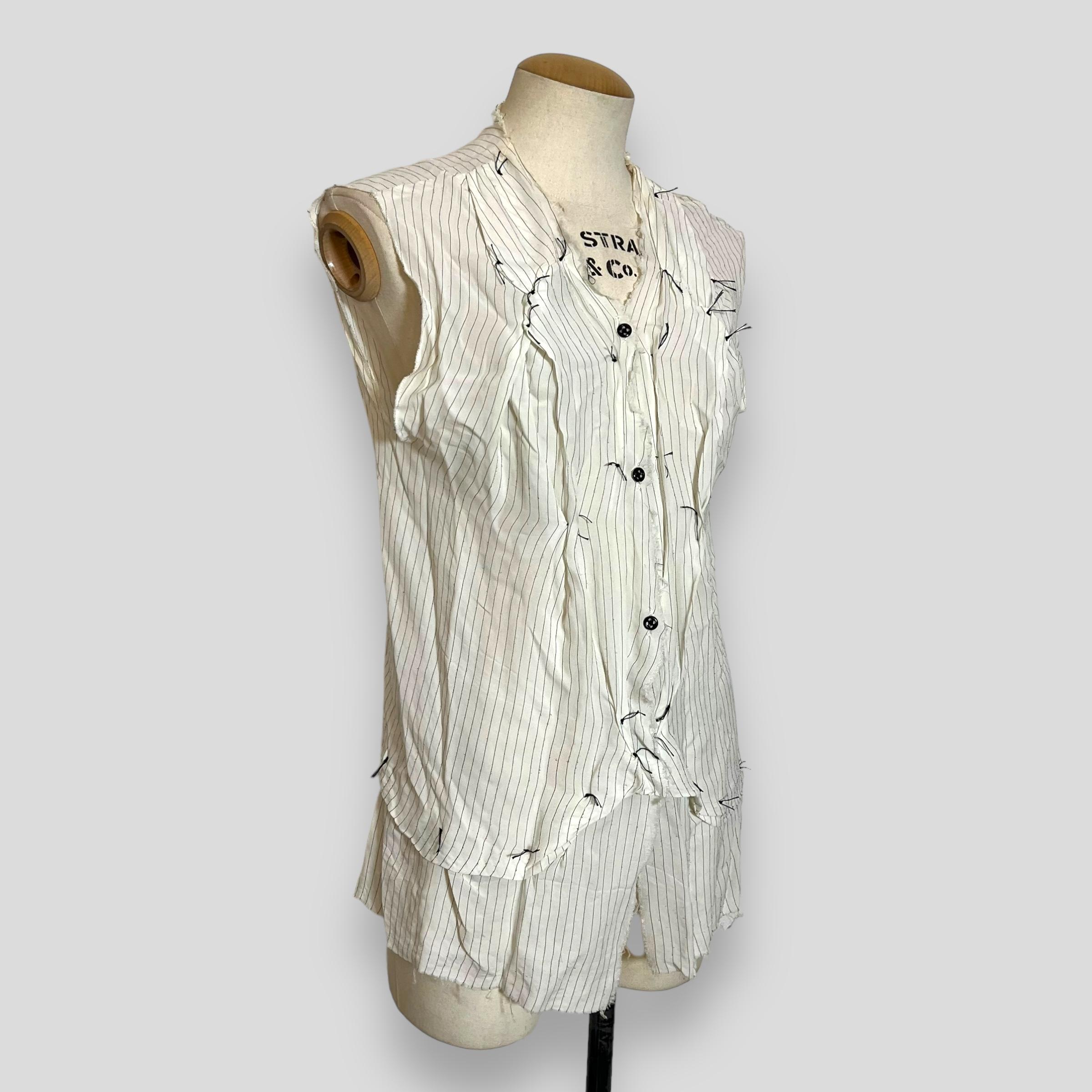 Maison Martin Margiela 2004 S/S white pinstripe blouse with gathered lapels 

Blouse from Maison Margiela's Spring 2004 runway collection epitomizes the avant-garde vision of designer Martin Margiela. Crafted from 100% rayon, the sleeveless white