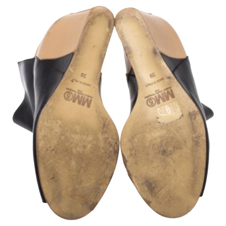 These peep-toe boots by Maison Martin Margiela provide high style that speaks volumes without saying a word. Crafted from black and beige-hued leather, this peep-toe pair features comfortable insoles and wedge heels.