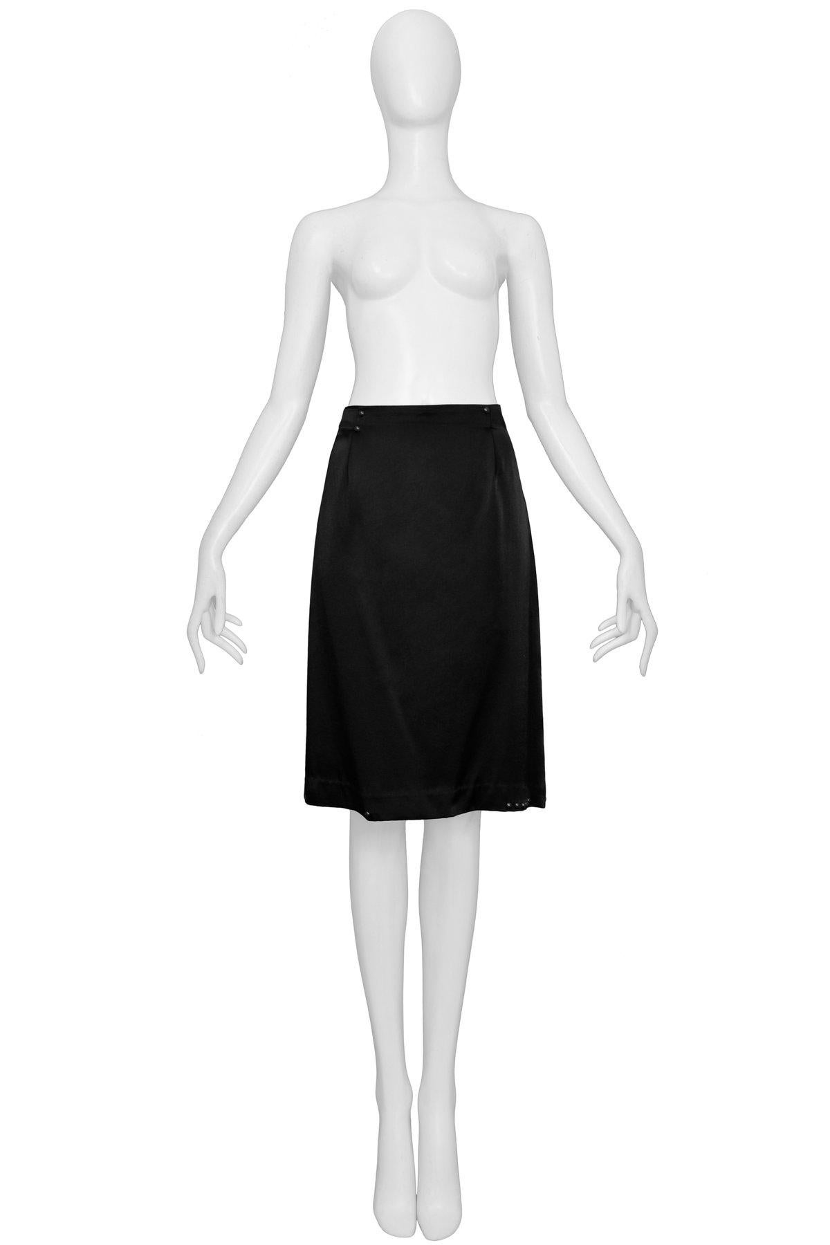 Resurrection Vintage is excited to offer a vintage Maison Martin Margiela black satin 20's style skirt with pleated yoke and gunmetal round studs at the front and back waistband and hemline.

Maison Martin Margiela
Size 42
100% Viscose
2006