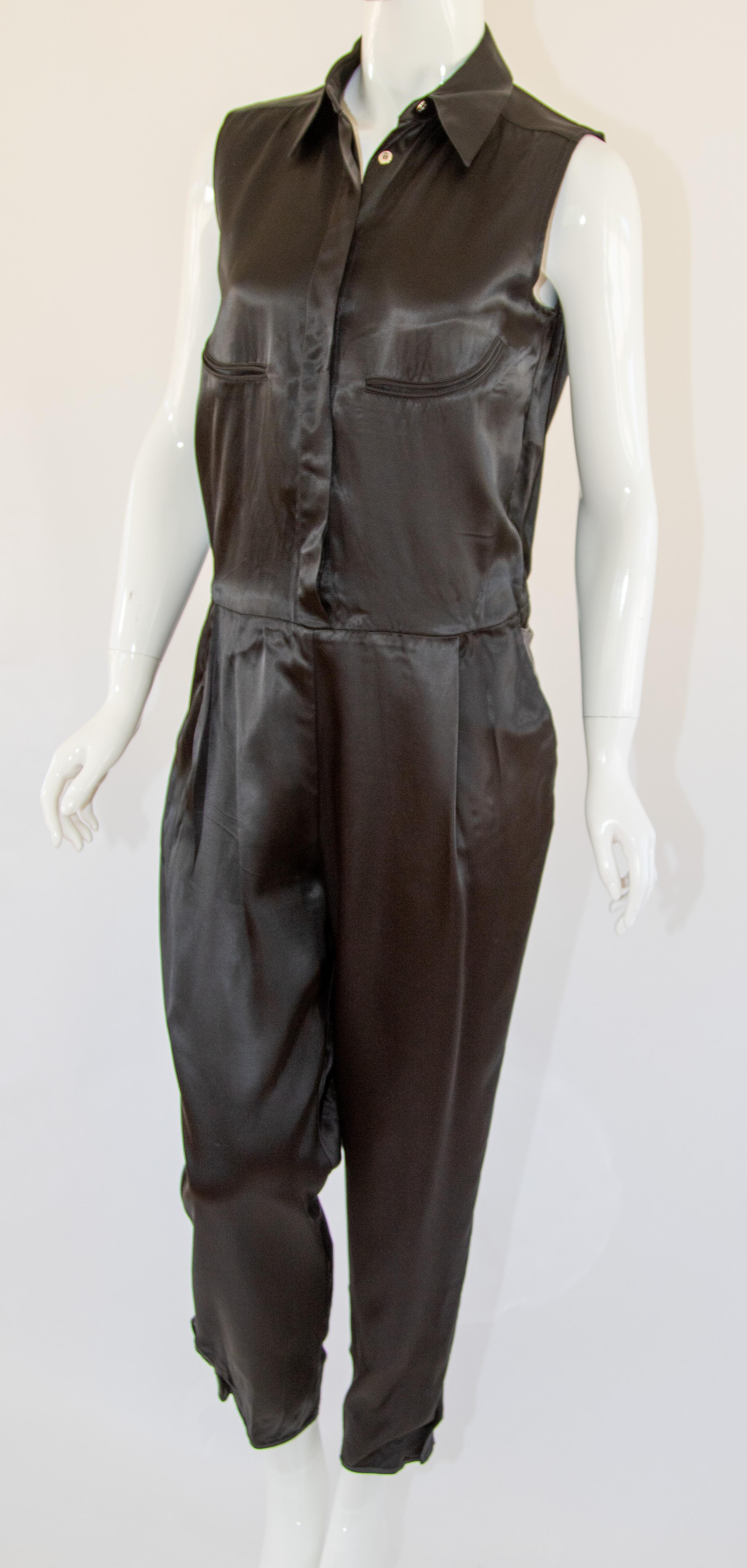 MM6 Tie back Maison Martin Margiela Black Jumpsuit sleeveless.
MM6 by Maison Martin Margiela Satin Sleeveless Jumpsuit, New with Tag.
Black MM6 by Maison Martin Margiella satin straight-leg jumpsuit with pointed collar, four pockets, grey sash tie