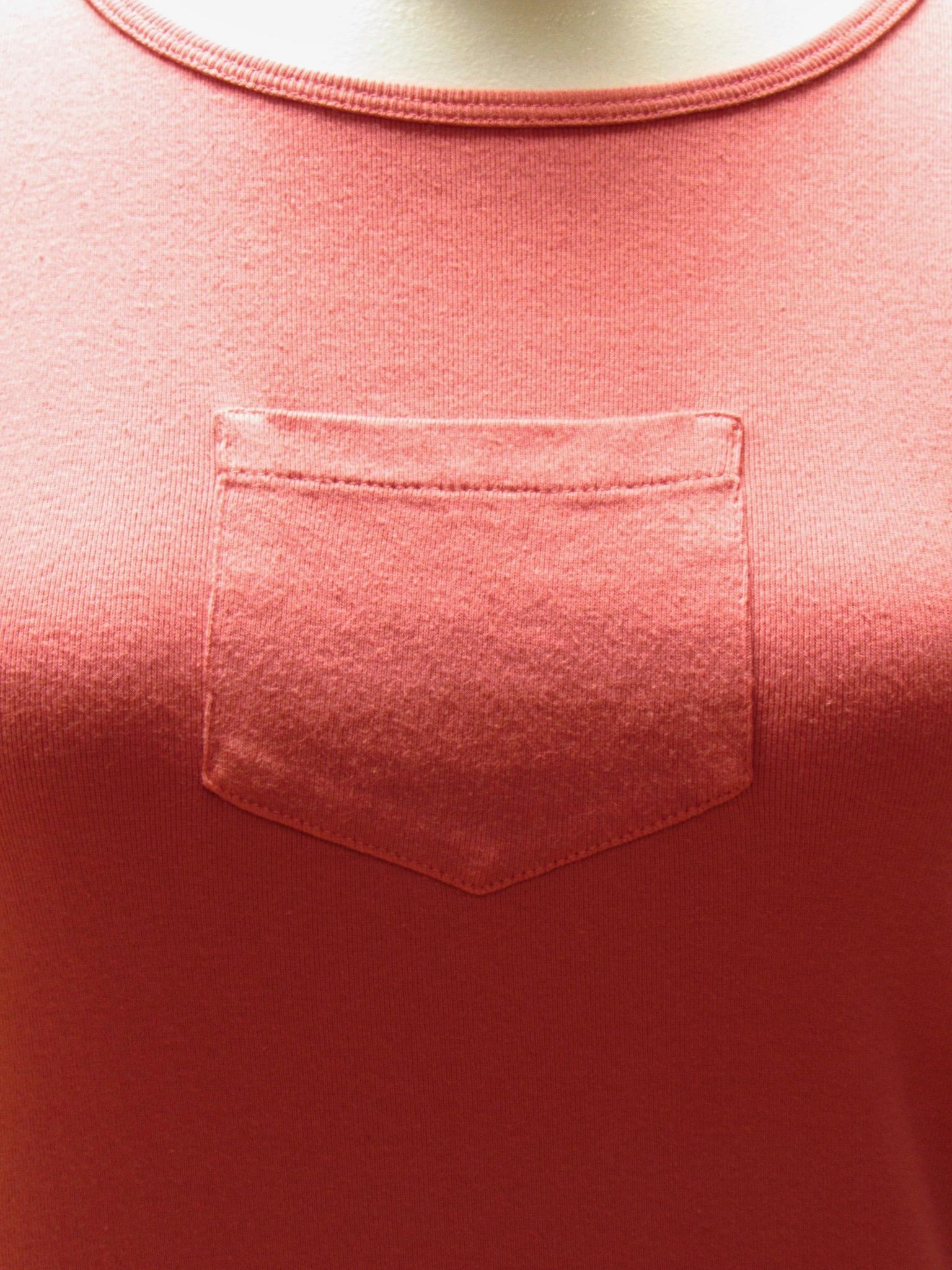 A coral cotton tee from Maison Martin Margiela stands out with a single breast pocket that sits front and center. 