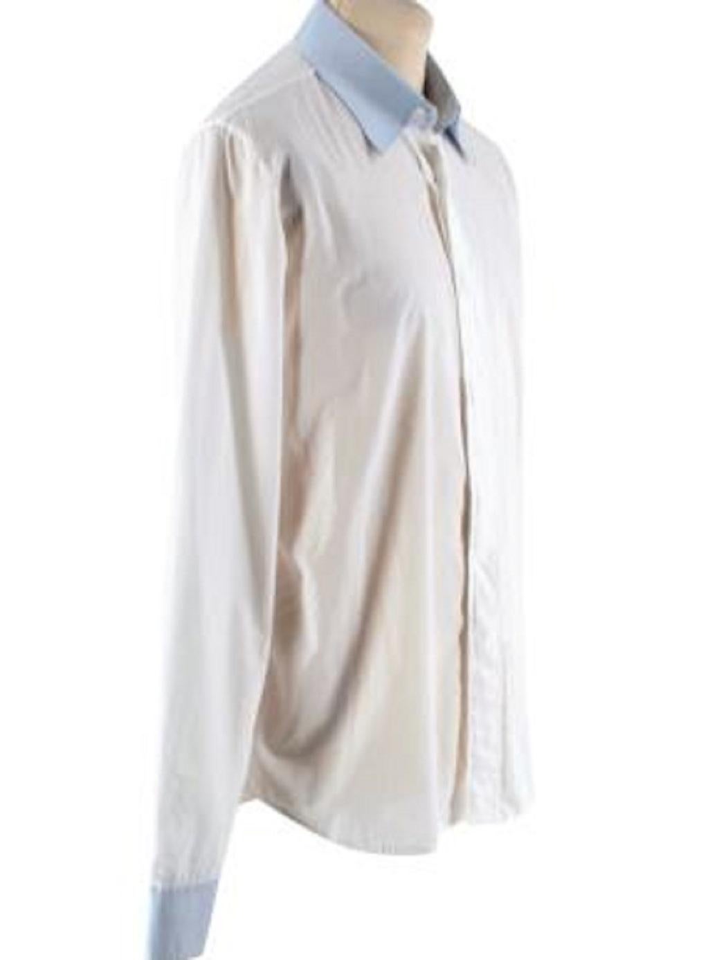 Maison Martin Margiela Cotton Voile White Long Sleeve Shirt

-Made of super soft and lightweight cotton voile 
-Gorgeous blue details to the collar and cuffs 
-Classic cut 
-Concealed button fastening to the front 
-Buttoned cuffs 
-Signature white