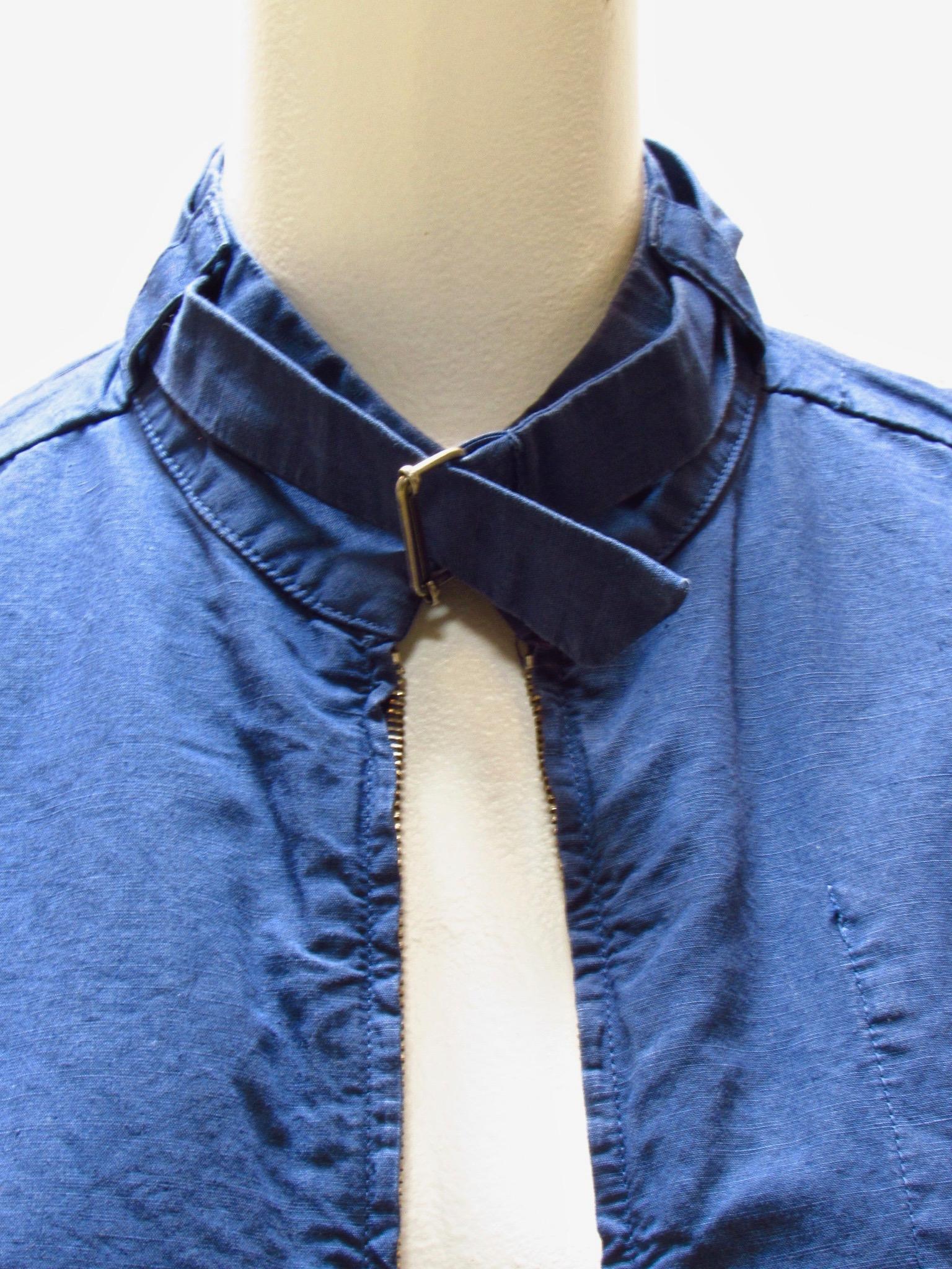 Lightweight navy blue cotton zip-front cropped jacket has two slit front pockets and a belted collar. 
