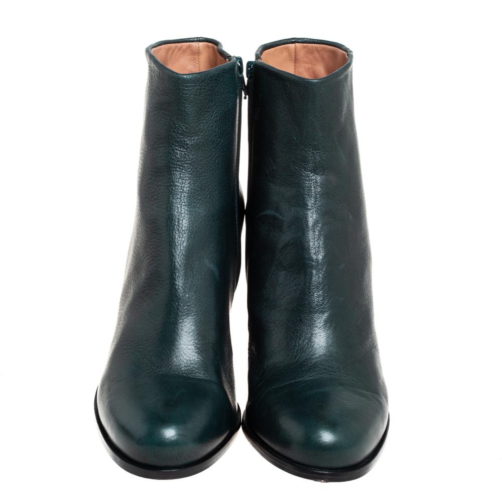 These creatively-designed ankle boots are by Maison Martin Margiela. Crafted using green leather, they are secured by zippers and set stop crooked heels—an illusion that seems like the heel has broken. You'll love wearing these statement boots.

