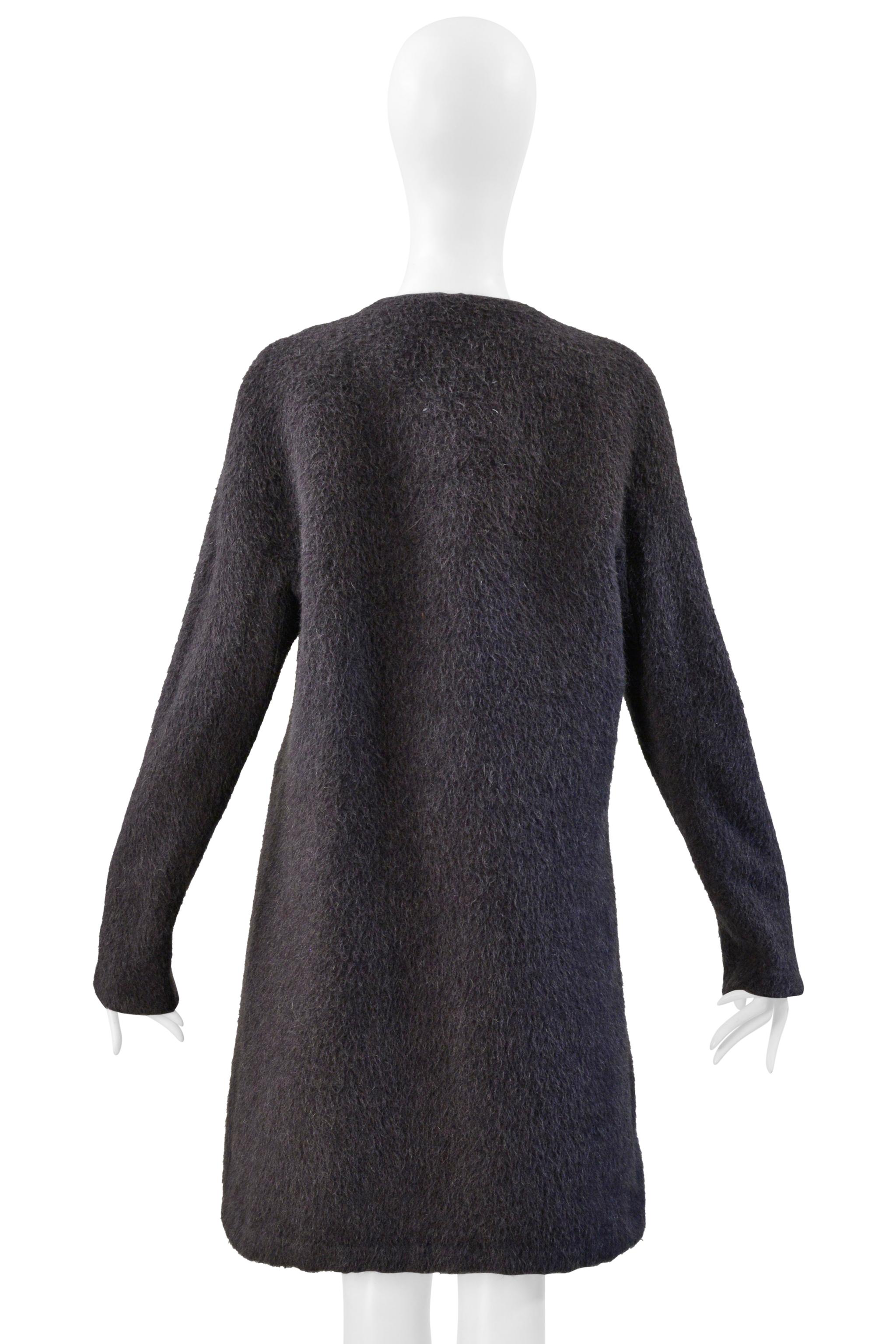 Resurrection Vintage is thrilled to offer a rare Maison Martin Margiela grey mohair coat with vertical zippers and a leather obi belt from the 2000 collection, featuring side zipper vents, cutouts under the arm, and hook and eye closures. See the