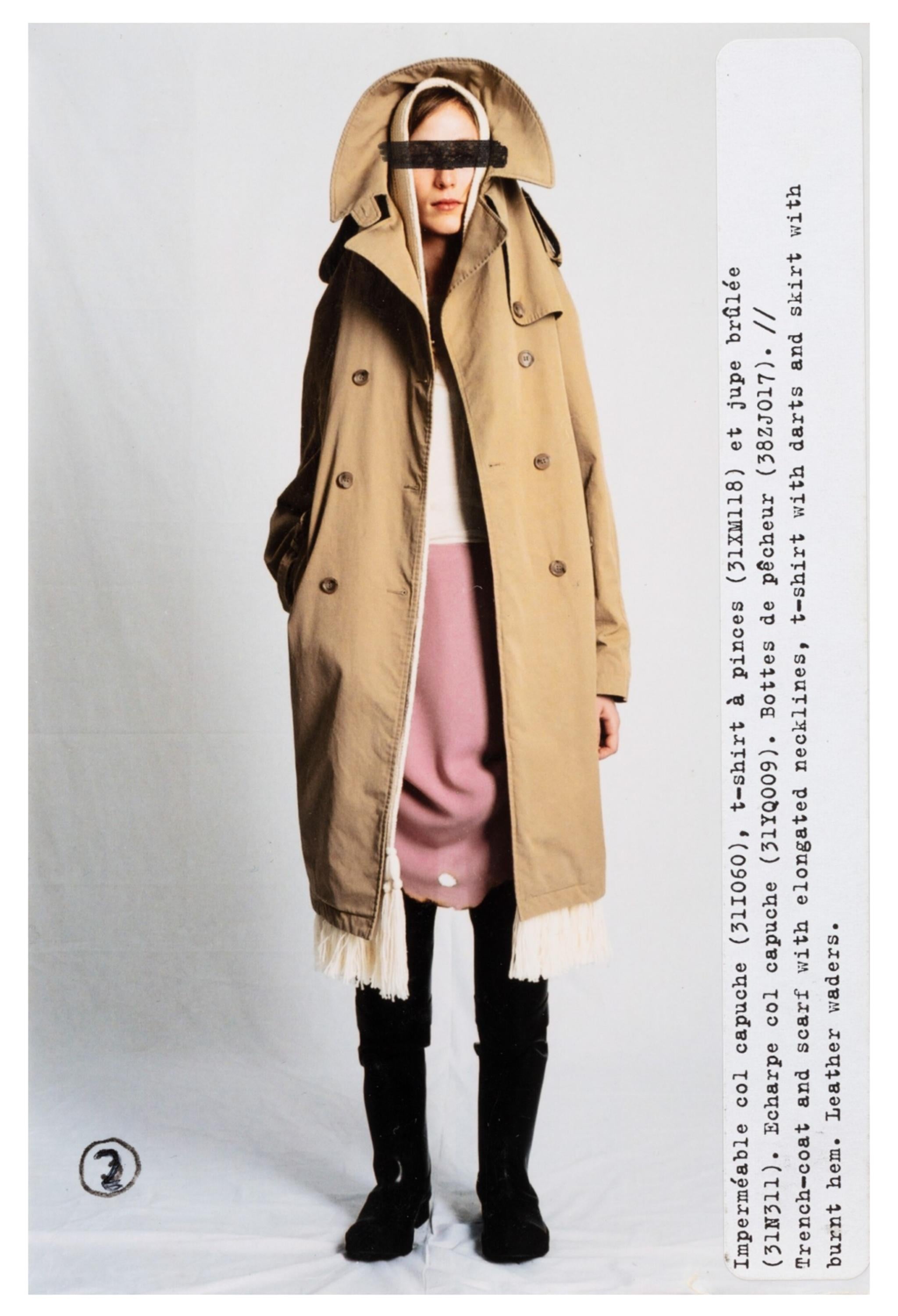 Resurrection Vintage is excited to offer a vintage Maison Martin Margiela khaki brown trench coat, featuring the iconic overhead hood design, double-breasted body, belt at the waist, straps at the cuffs, side pockets, cotton lining, and a