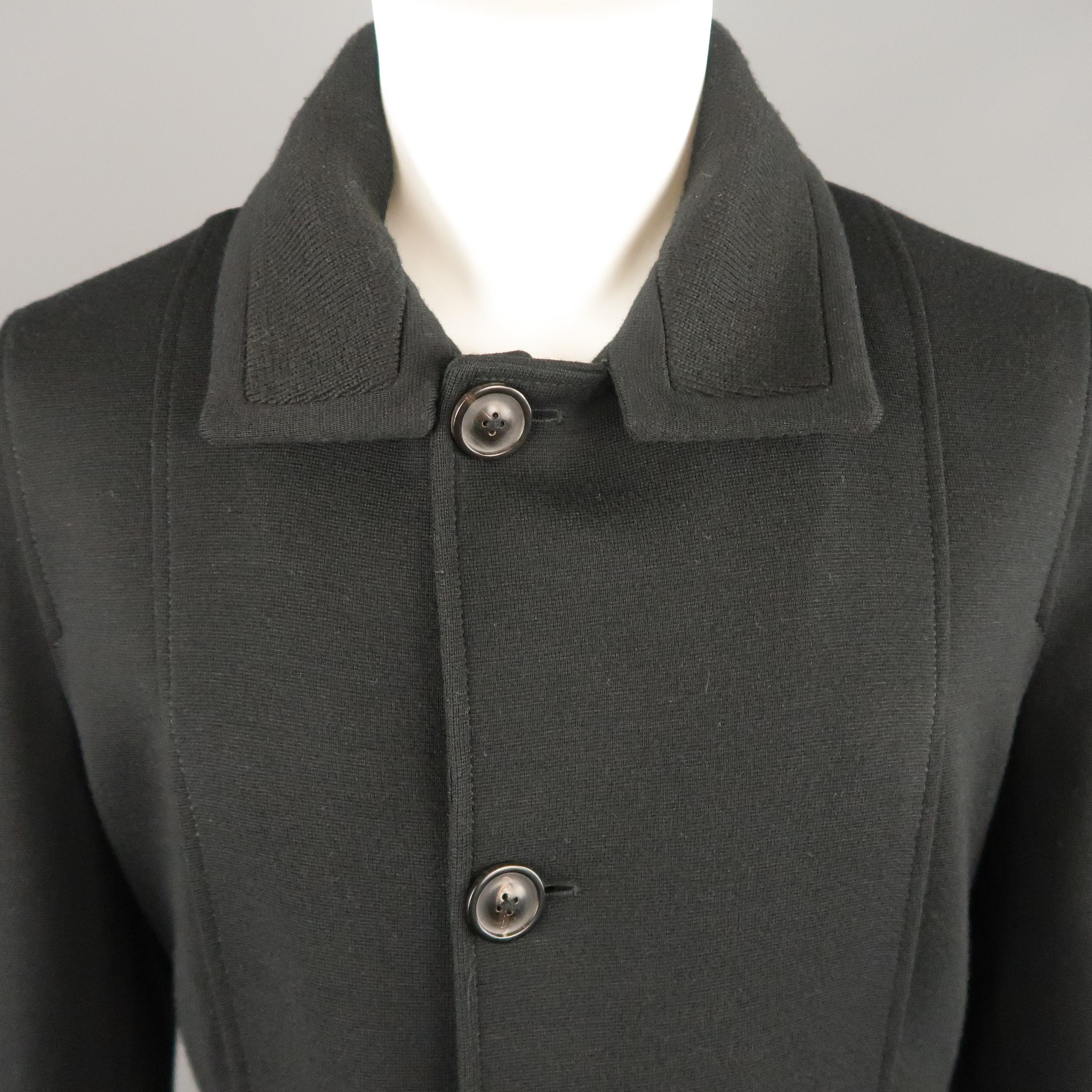 MAISON MARTIN MARGIELA coat comes in black wool blend knit with a textured spread  collar, single breasted button up front, slit chest pockets, and geometric side pockets. Made in Italy.
 
Excellent Pre-Owned Condition.
Marked: IT 50
