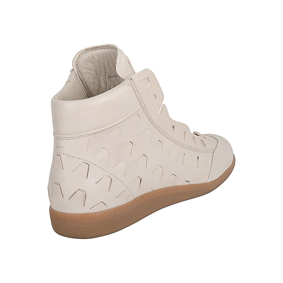 Rare Maison Martin Margiela men's high top sneaker with cut out detail. 
High top sneaker in bone.
Zip top and cut out detail on replica leather. 
Toe on one foot has some light markings - see photo please.
Comes with signature box.
NEW or NEVER