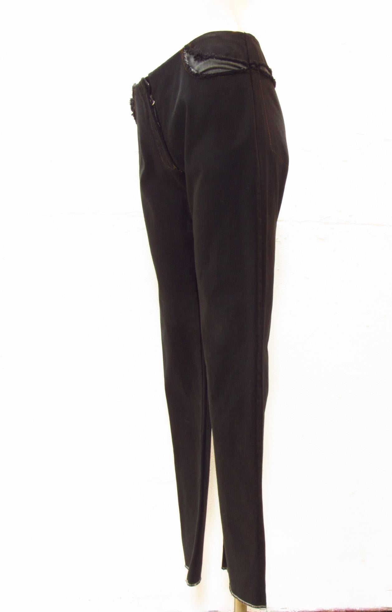 Black pants from vintage Maison Martin Margiela are unique with exposed denim seams along the waist at the pocket openings. Clean front with a short zip fly in front. 