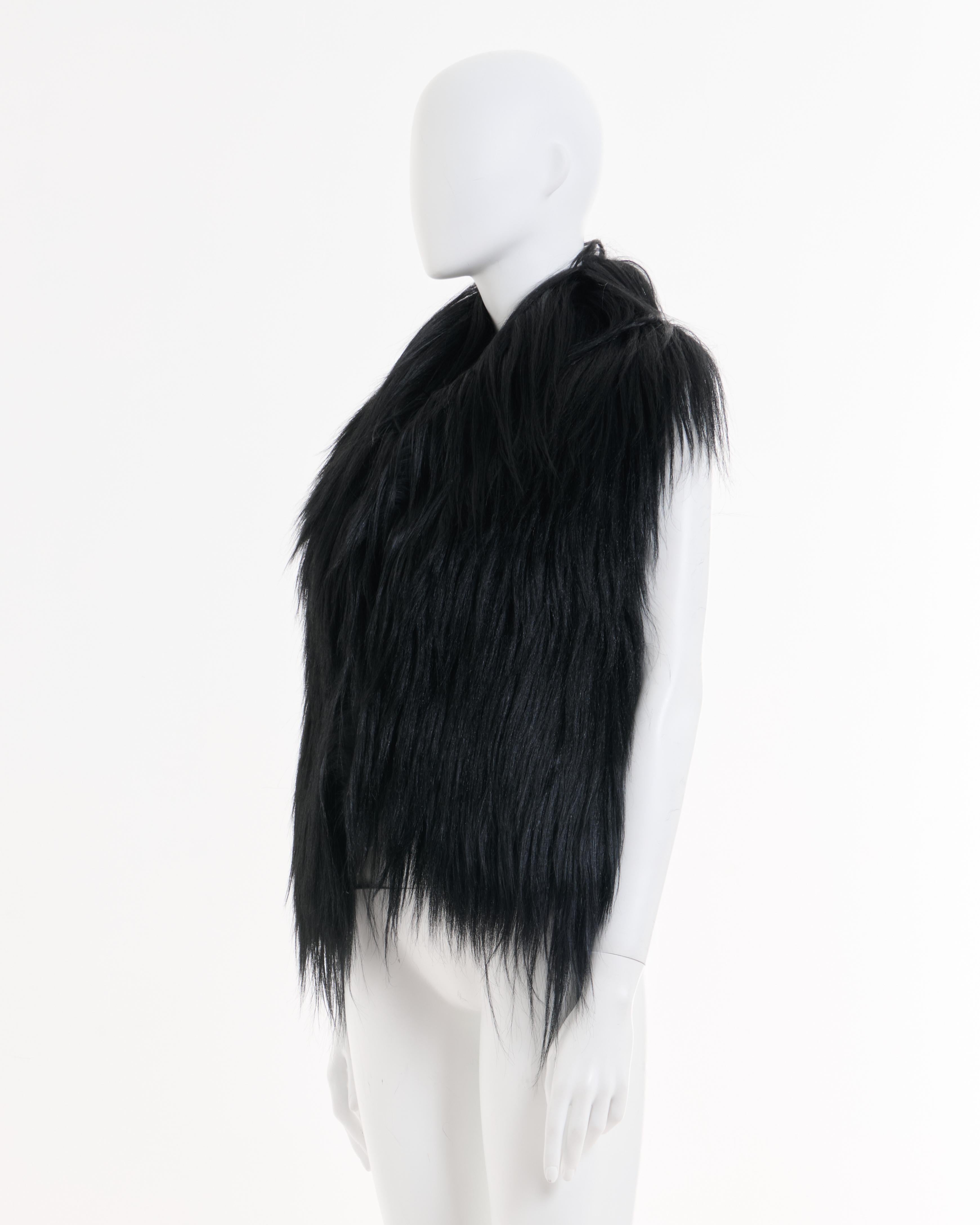 - Maison Martin Margiela Black long goat hair gilet
- Sold by Skof.Archive 
- Designed by Martin Margiela 
- Pre-Fall 2011 Collection 
- Back in wool fabric 
- Fully viscose lining 
- Small hook and eye frontal closure 
- Size: FR 38 - IT 42 - UK 10