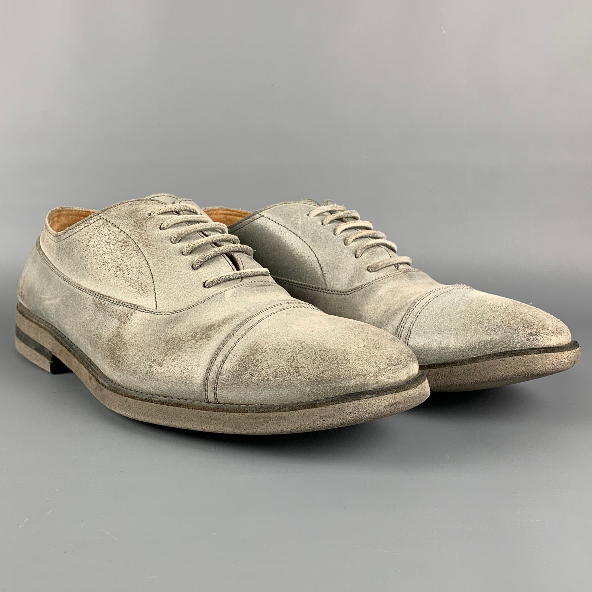 MAISON MARTIN MARGIELA shoes comes in a grey distressed suede featuring a cap toe and a lace up closure. Made in Italy.

Very Good Pre-Owned Condition.
Marked: 44

Outsole: 12.5 in. x 4.5 in. 