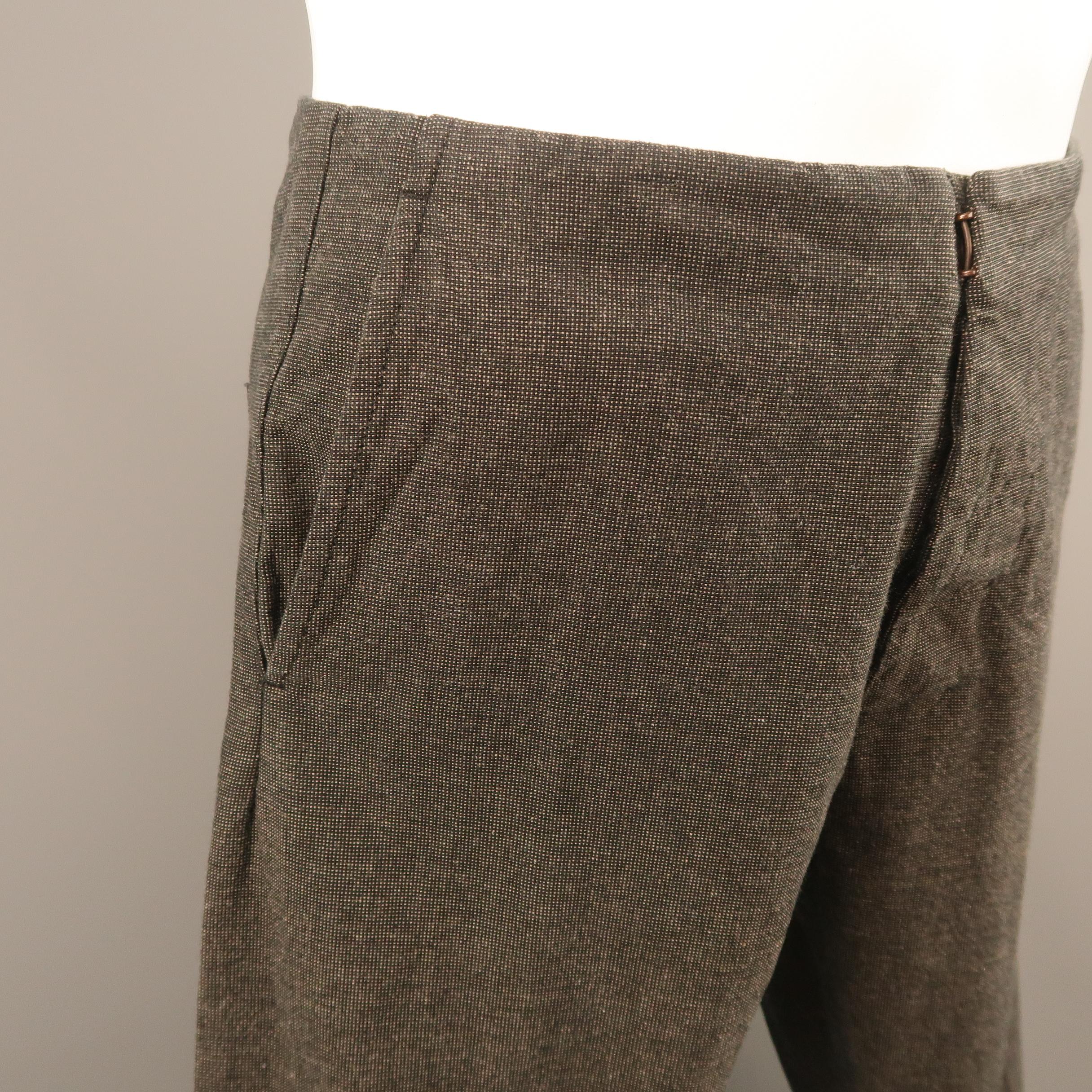MAISON MARTIN MARGIELA pants come in gray nailhead cotton canvas with a band free waist, hidden button fly with hook eye closure, and signature stitch back. Made in Romania.
 
Very Good Pre-Owned Condition.
Marked: IT 46
 
Measurements:
 
Waist: 32