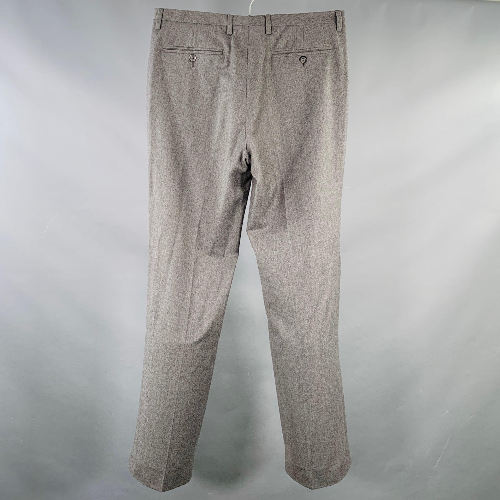 MAISON MARTIN MARGIELA dress pants
in a heather grey wool featuring a flat front style, straight leg, and button fly closure. Made in Italy.Good Pre-Owned Condition. Moderate signs of wear, as is. 

Marked:   IT 48 

Measurements: 
  Waist: 32