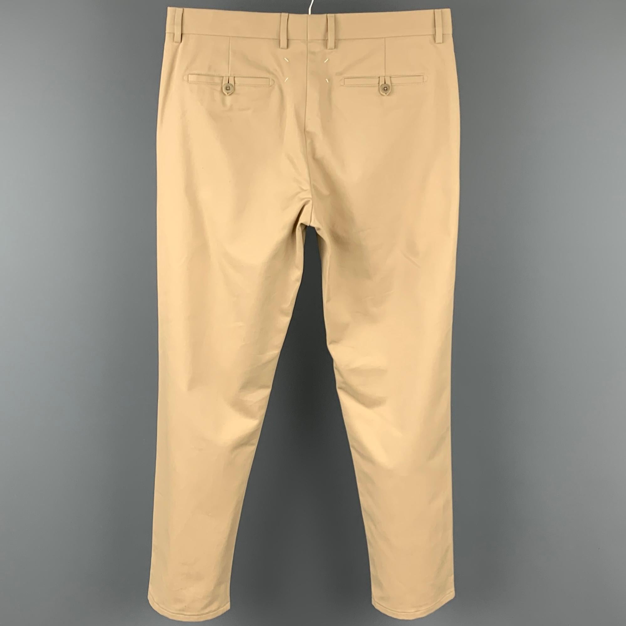 MAISON MARTIN MARGIELA casual pants comes in a khaki cotton featuring a straight leg, slit pockets, and a zip fly closure. Made in Romania.

New With Tags. 
Marked: 50

Measurements:

Waist: 36 in.
Rise: 11 in.
Inseam: 30 in