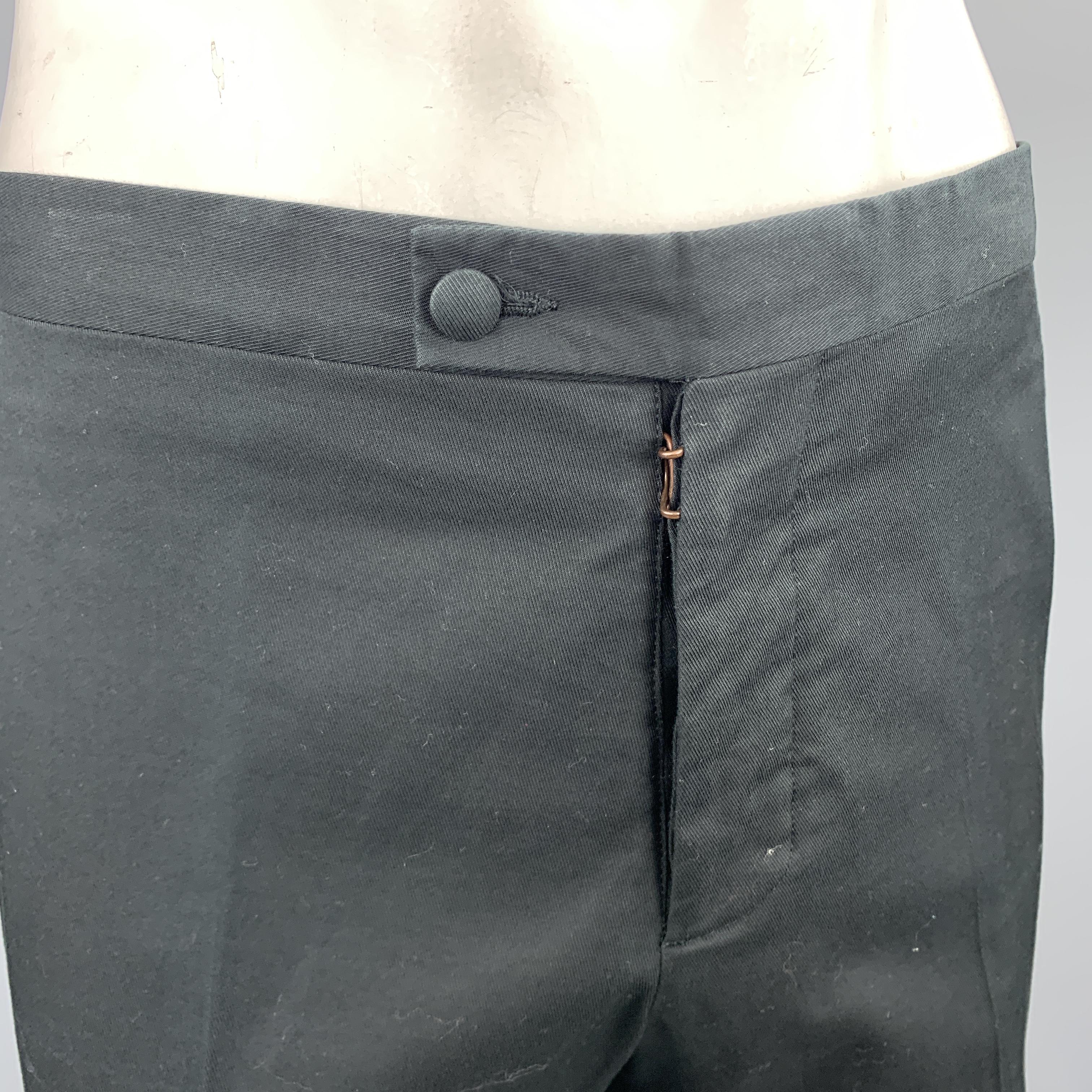 MAISON MARTIN MARGIELA flat front pants come in black woven cotton with a tab waistband and white side stripe. Made in Italy.

Excellent Pre-Owned Condition.
Marked: SLIM IT 52

Measurements:

Waist: 38 in.
Rise: 11 in.
Inseam: 35 in.