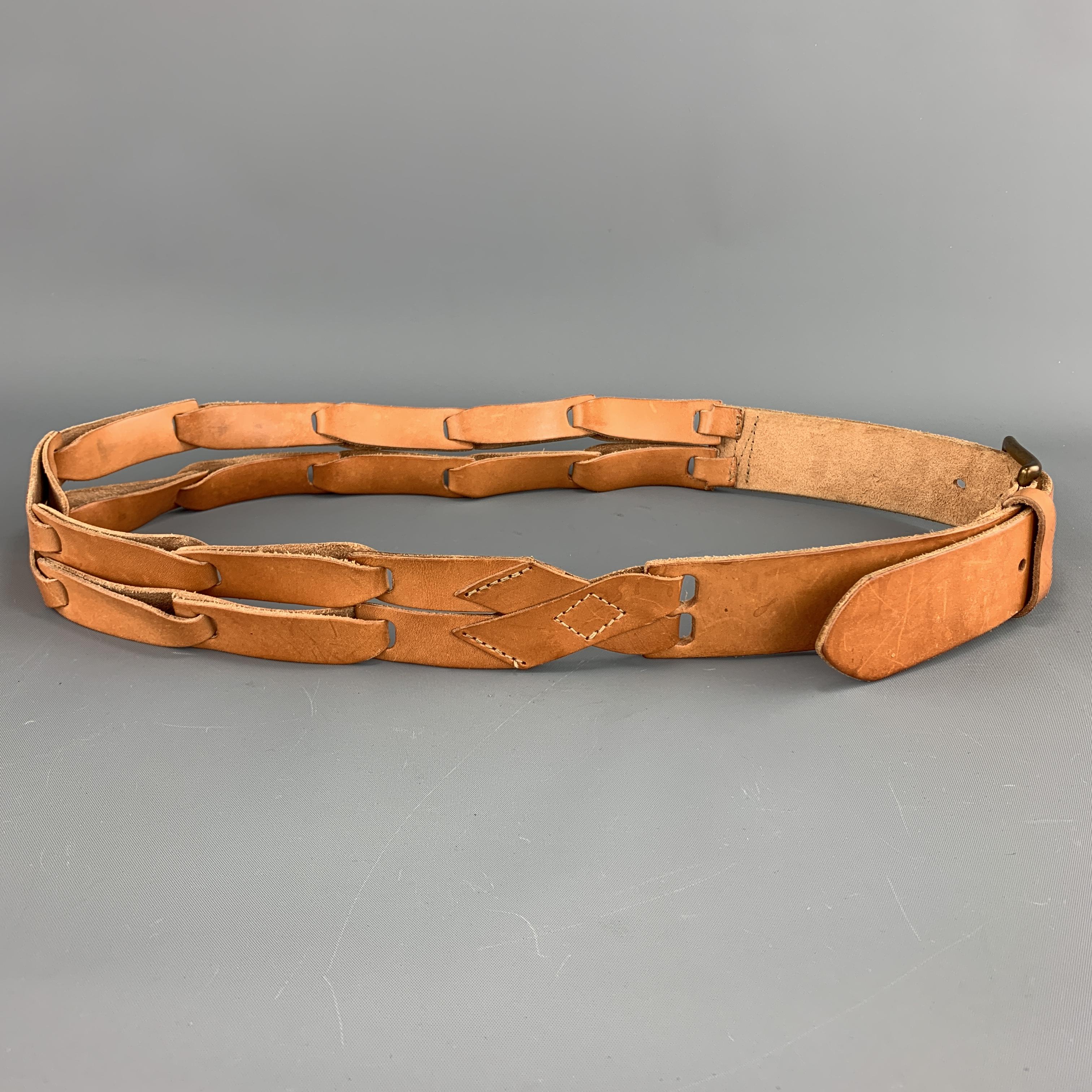 MAISON MARTIN MARGIELA belt comes in tan leather with an antique gold tone buckle and double link straps detail. Made in Italy.

Very Good Pre-Owned Condition.
Marked: 95

Length: 45 in.
Width: 1.5 in.
Fits: 37-41 in.