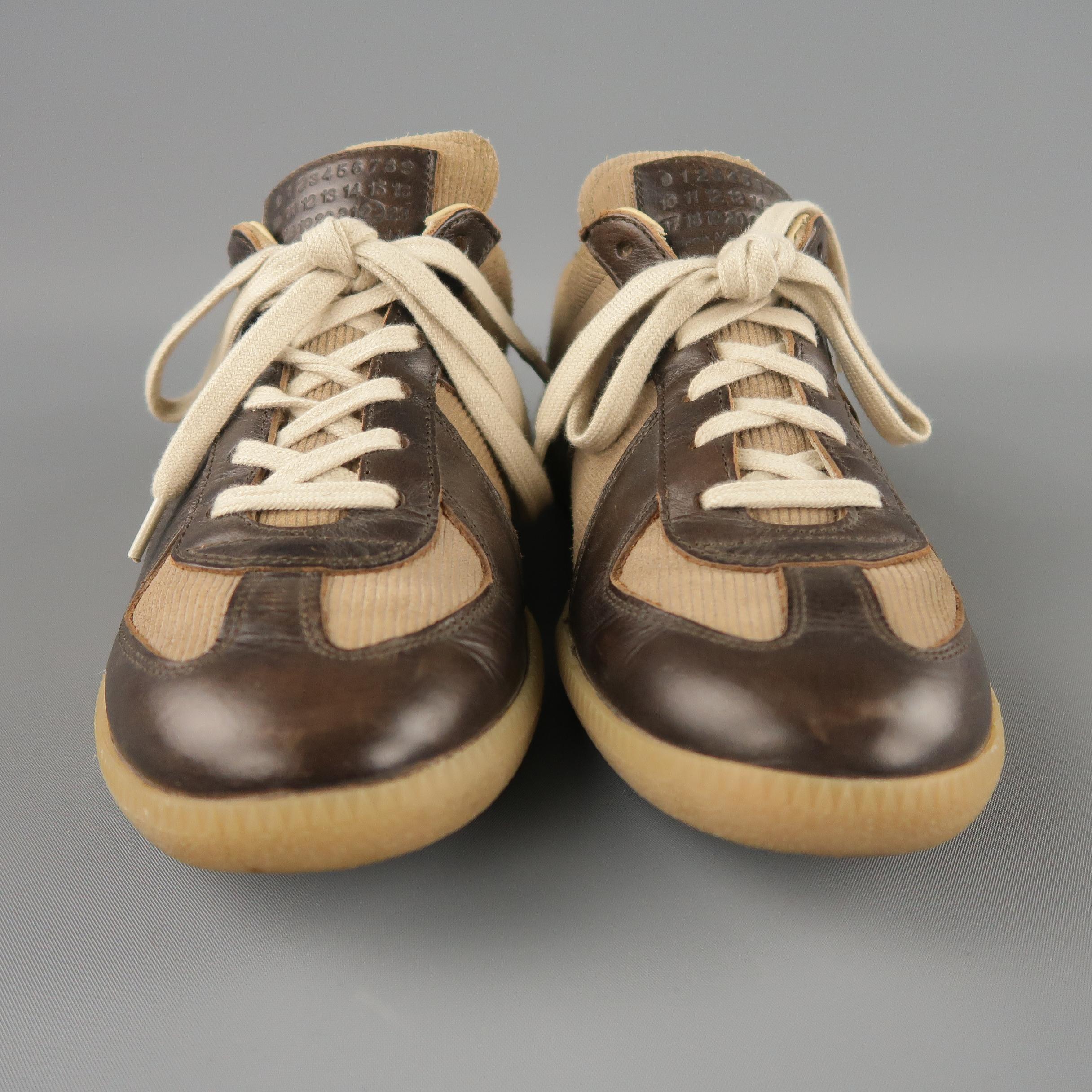 MAISON MARTIN MARGIELA 'REPLICA' low top sneaker comes in a brown canvas, leather trim details, and a rubber sole. Made in Italy.
 
Excellent Pre-Owned Condition.
Marked: 40
 
Measurements:
 
Width: 4 in.
Length: 11 in.