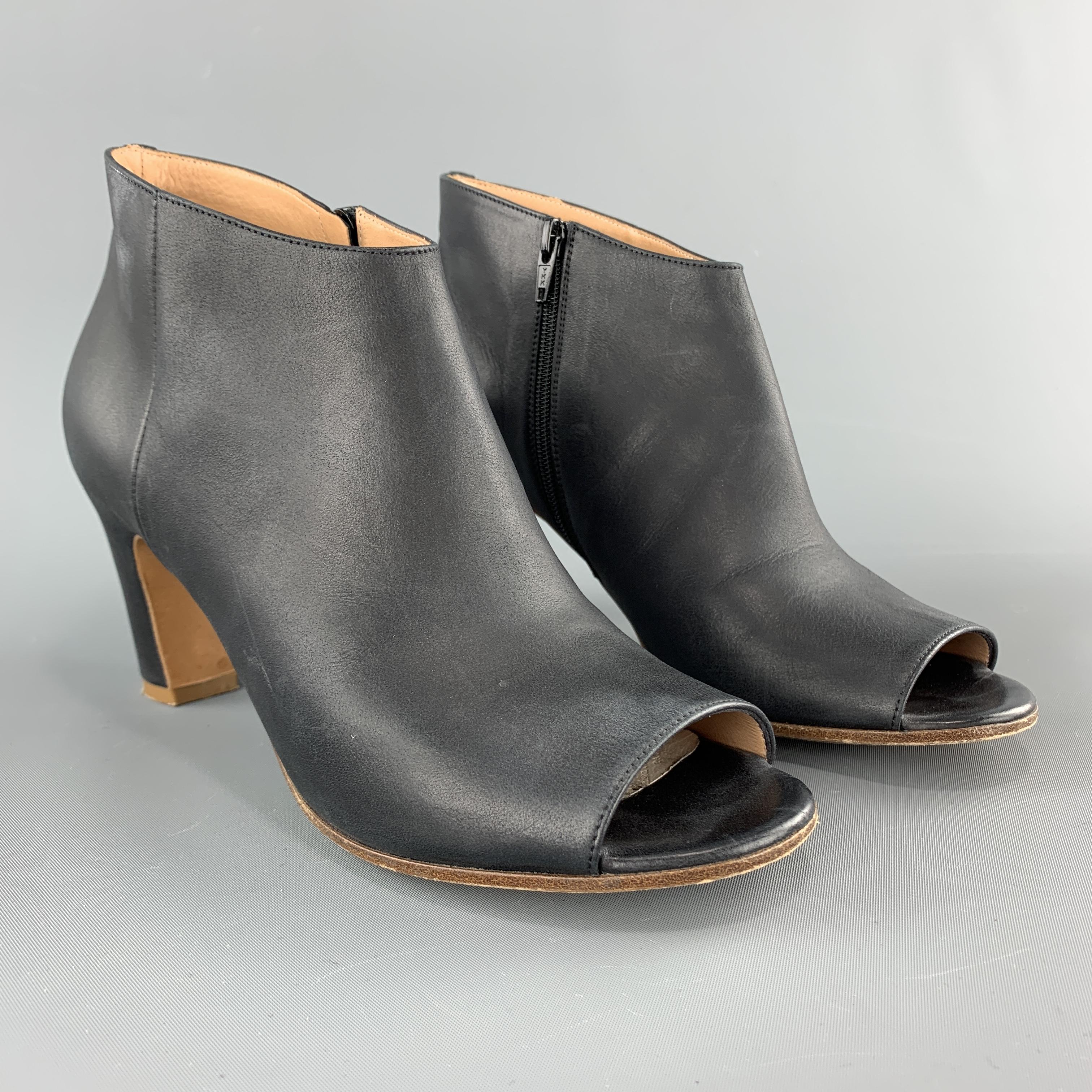 MAISON MARTIN MARGIELA ankle booties come in smooth navy leather with a peep toe, inner zip, covered heel, and white back stitch. Minor Wear. As-is. Made in Italy.

Good Pre-Owned Condition.
Marked: IT 37.5
Original Retail Price: $890.00

Heel: 3 in.