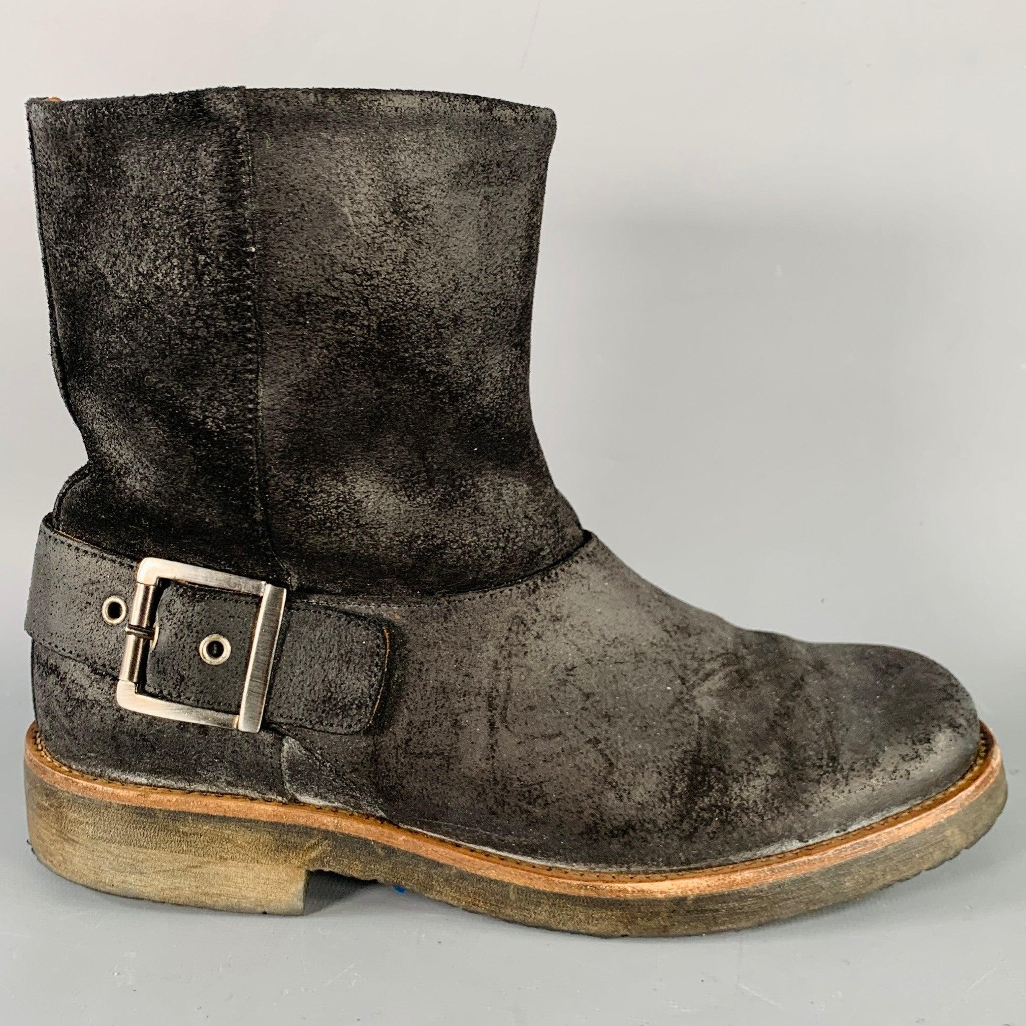 MAISON MARTIN MARGIELA boots
in a black roughout leather featuring an ankle style, distressed design, and pull on closure with silver tone metal buckle. Made in Italy.Very Good Pre-Owned Condition. 

Marked:   IT 38Length: 10.25 inches  Width: 3.75