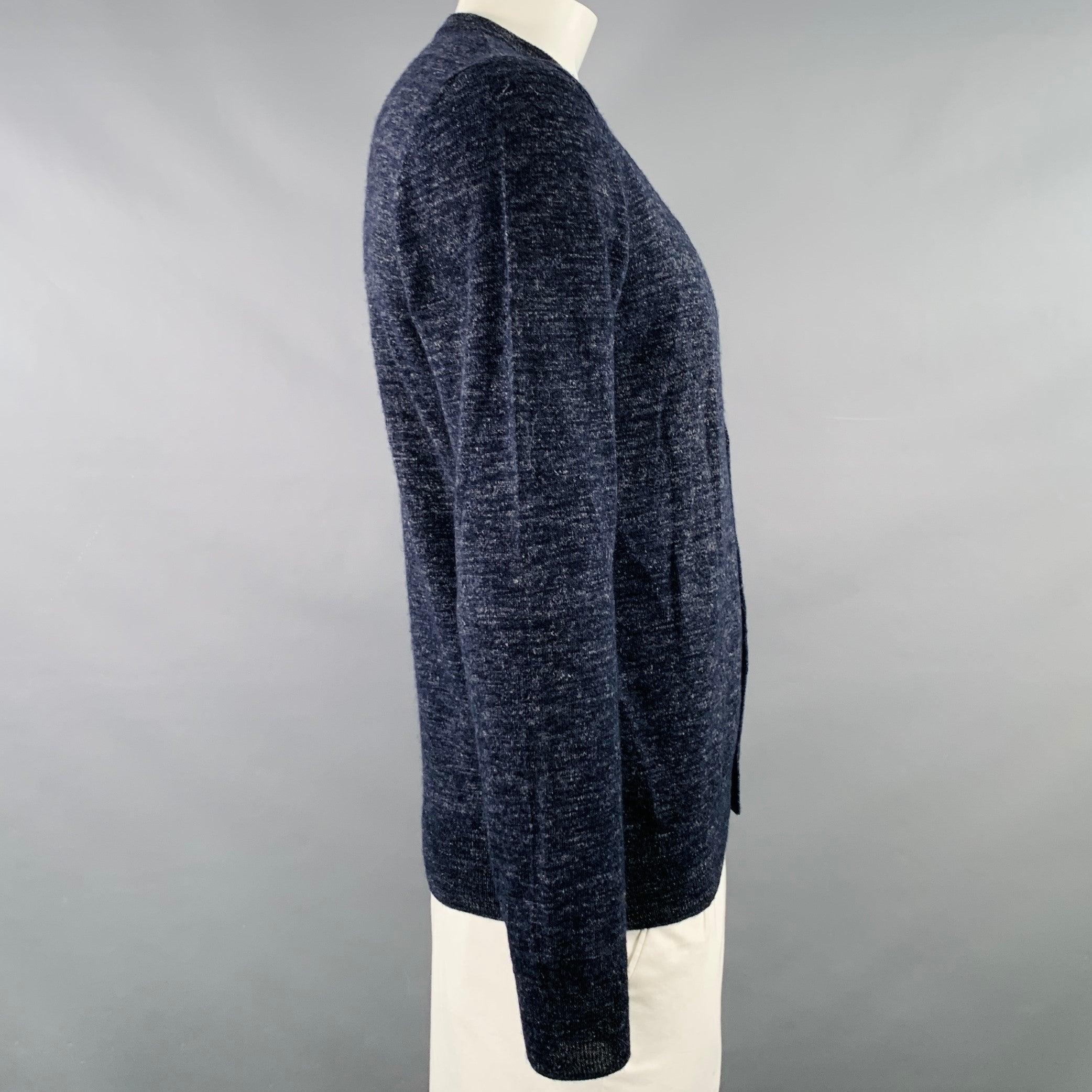 MAISON MARTIN MARGIELA sweater
in a heather navy and grey wool flax blend knit featuring a faux vest layer, crew neck, and button closure. Made in Romania.Very Good Pre-Owned Condition. Minor pilling around sleeves and sides. 

Marked:   L