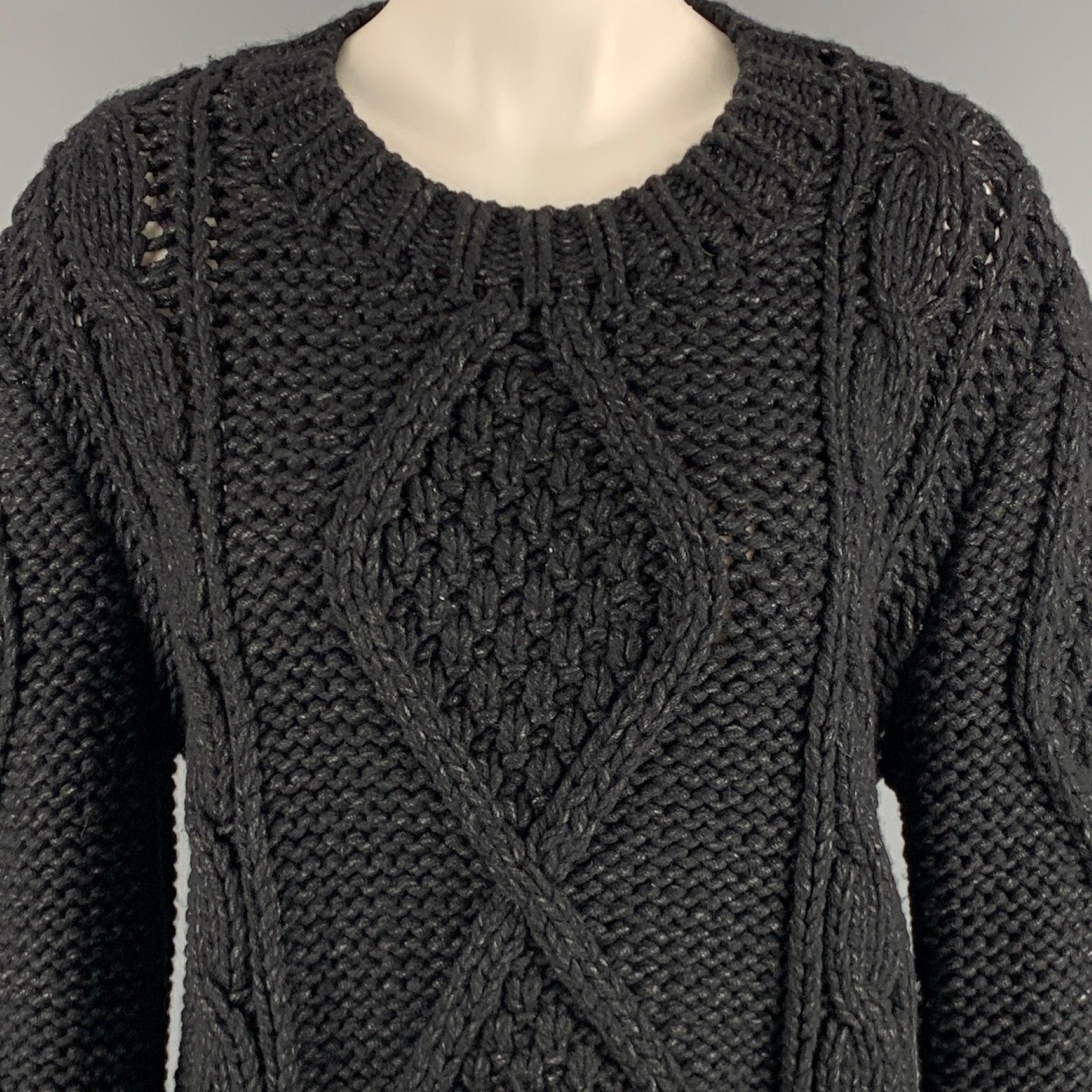 MAISON MARTIN MARGIELA sweater
in a
black and grey wool blend fabric featuring a fisherman style cable knit, long sleeves, and scoop neck. Made in Romania.Very Good Pre-Owned Condition. Minor pilling. 

Marked:   6 

Measurements: 
 
Shoulder: 17.5