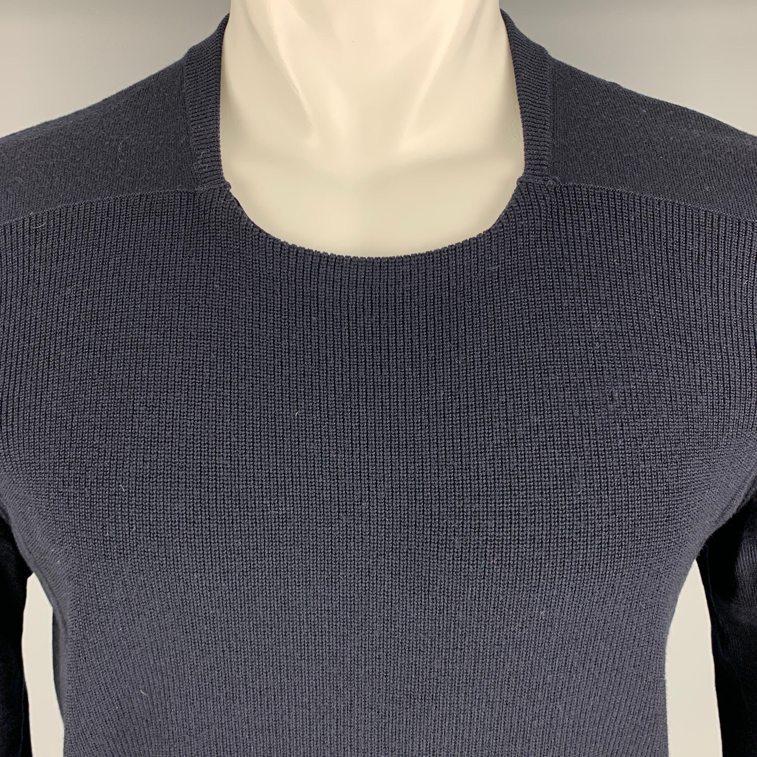 MAISON MARTIN MARGIELA pullover
in a navy wool knit featuring a waffle knit front, blouson sleeves, and scoop neck. Made in Romania.Excellent Pre-Owned Condition. 

Marked:   14 

Measurements: 
 
Shoulder: 16.5 inches Chest: 40 inches Sleeve: 27