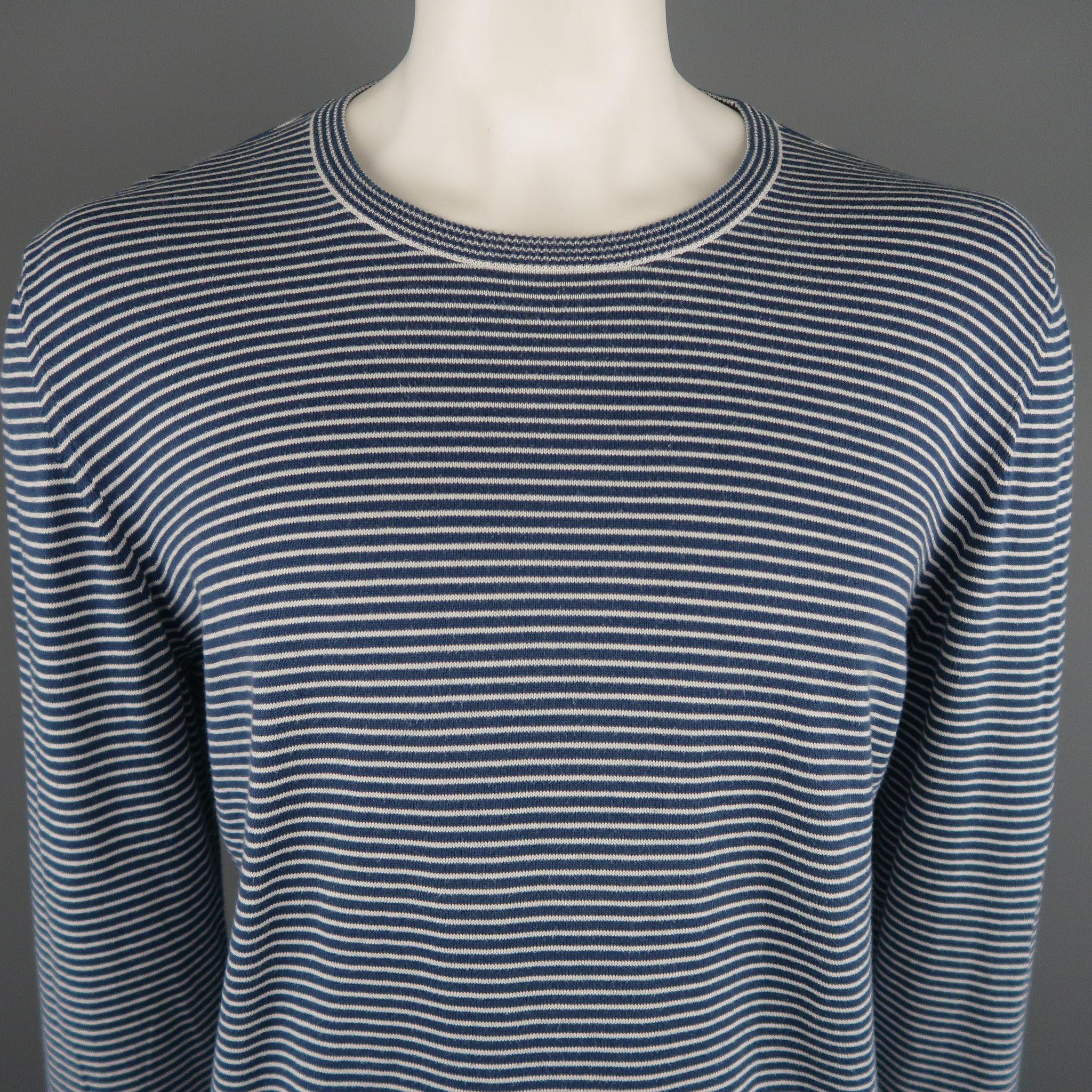 MAISON MARTIN MARGIELA Pullover sweater comes in navy and white tones in a striped cotton material, with a crewneck and ribbed cuffs and hem. Missing Tag. Made in Italy.

Excellent Pre-Owned Condition.
Marked: No size marked, size estimated from