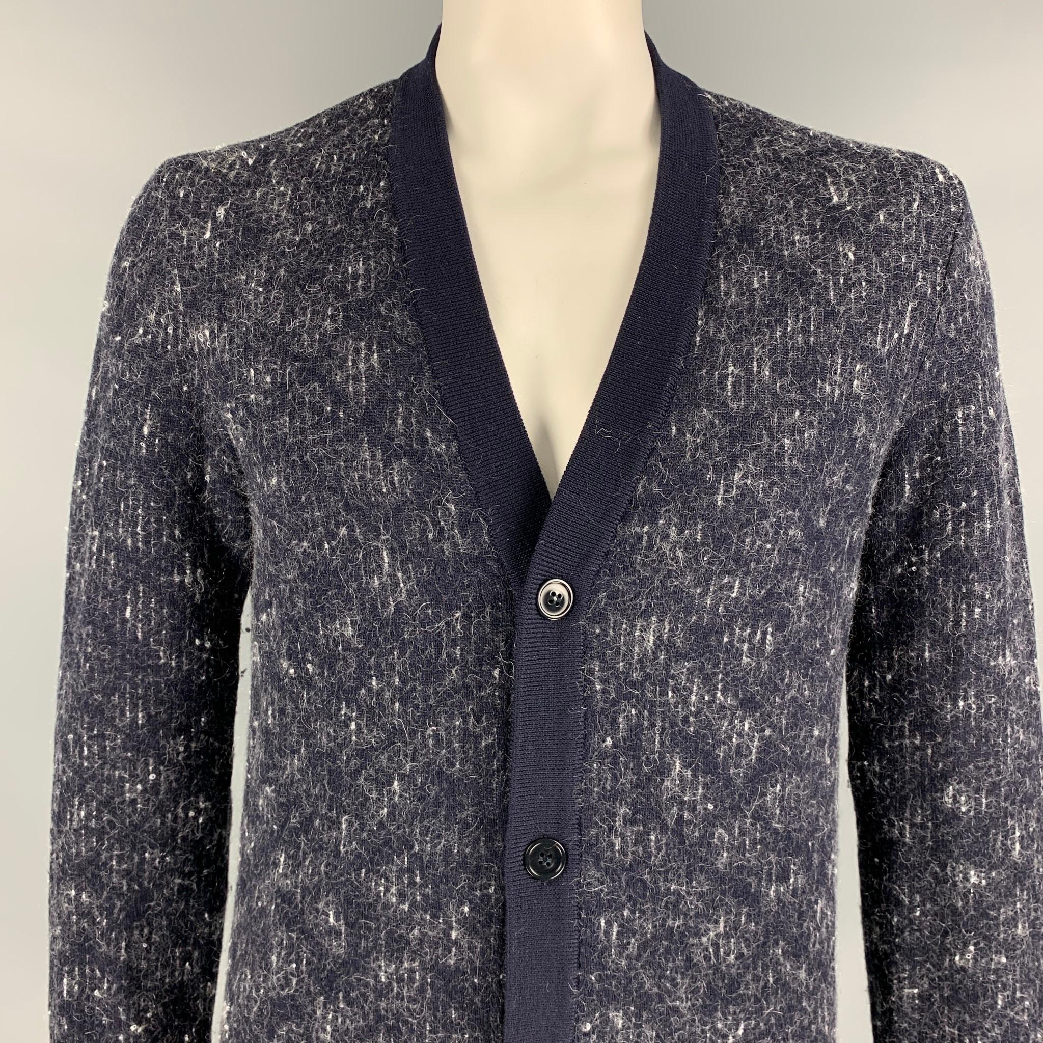MAISON MARTIN MARGIELA cardigan comes in a navy & white stripe wool blend featuring a ribbed hem and a buttoned closure. 

Very Good Pre-Owned Condition.
Marked: XL

Measurements:

Shoulder: 17.5 in.
Chest: 42 in.
Sleeve: 31.5 in.
Length: 29.5 in. 