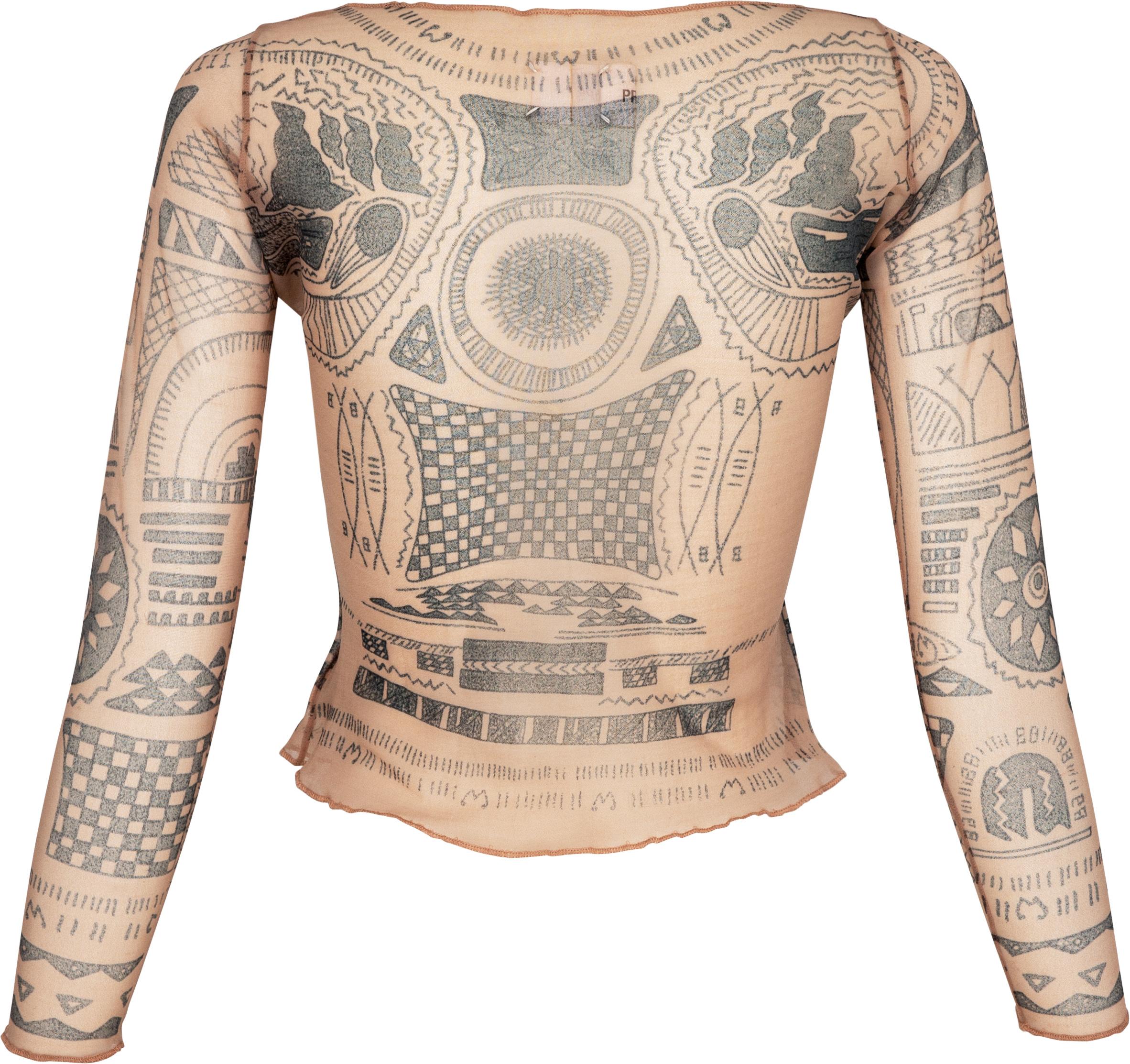 Sheer top in mesh adorned with tribal tattoo motifs from French Polynesia. Designed from Martin's first and historic runway show in 1989 and re-visited for his spring 1994 
