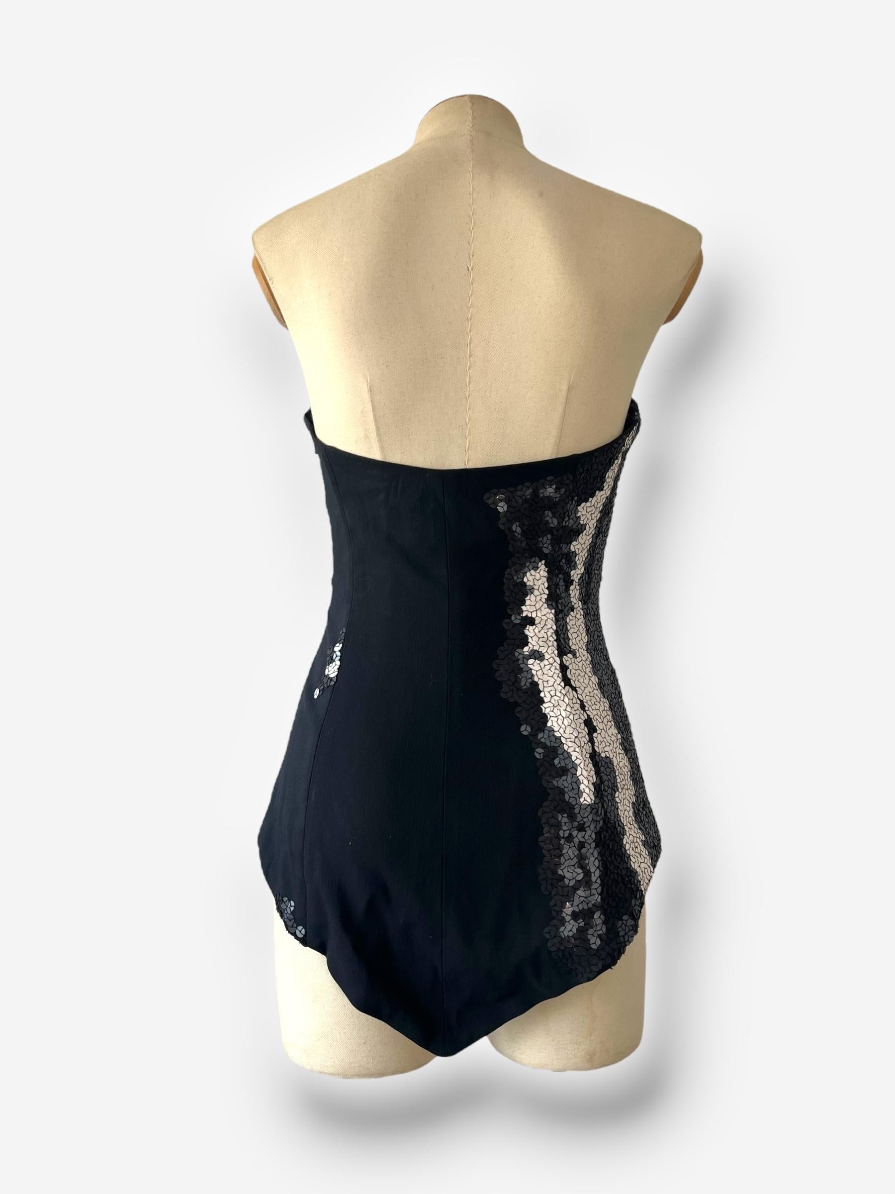 Step into the boundary-pushing world of Maison Martin Margiela with this striking corset from the Spring/Summer 2008 collection. Featuring strategically placed sequins that highlight and accentuate the body’s contours, it exudes a futuristic allure.