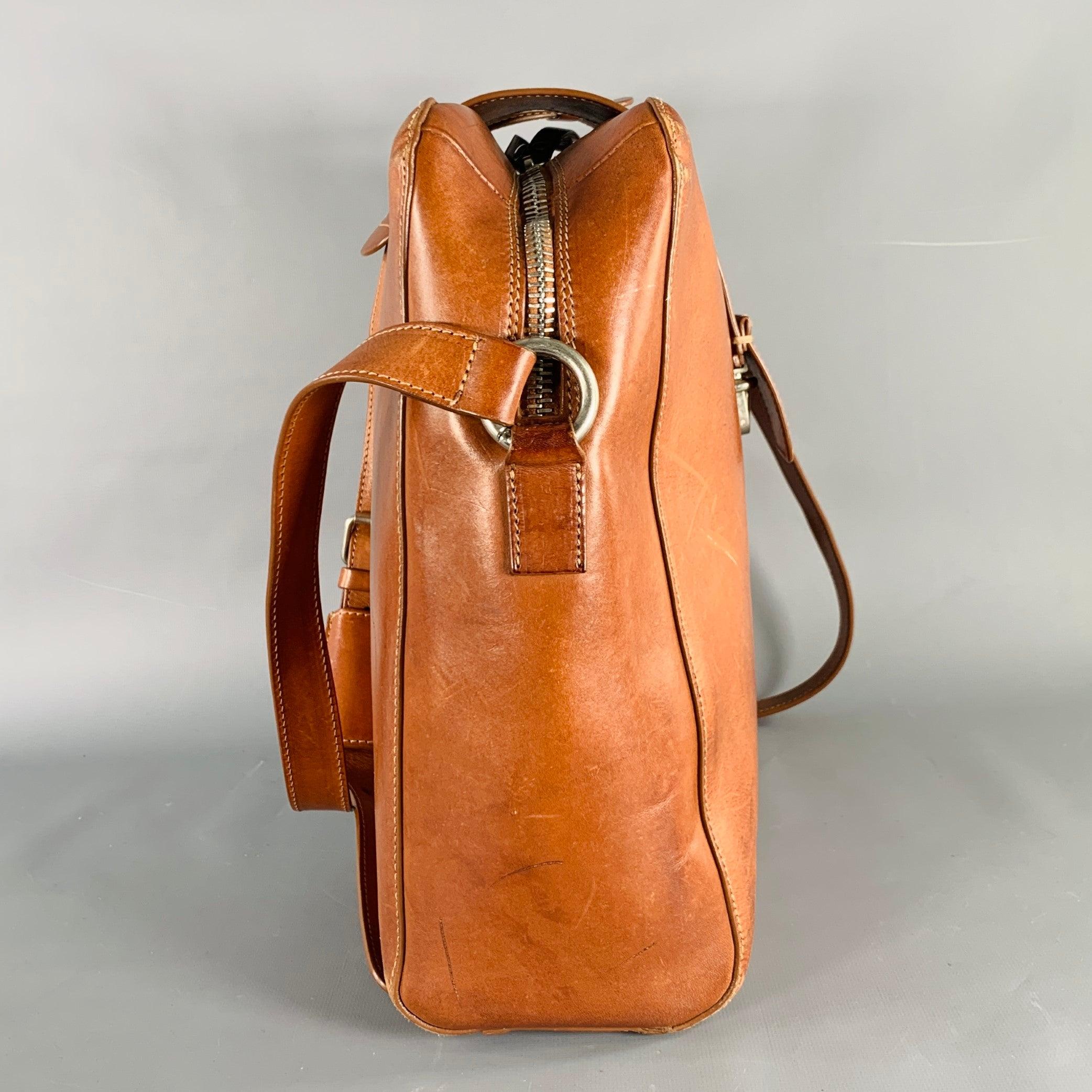 MAISON MARTIN MARGIELA shoulder bag
in a tan calfskin leather featuring a distressed design, adjustable shoulder strap, and zip closure with push lock. Made in Italy.Very Good Pre-Owned Condition. Minor signs of wear. 

Marked:   S35WG0112 SX9298
