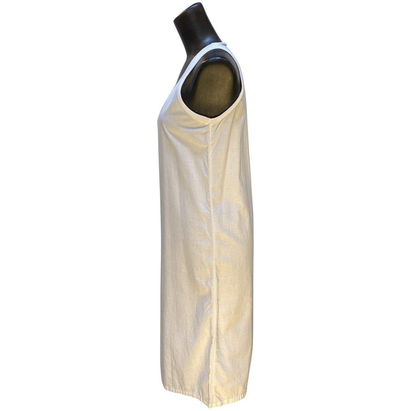 The possibilities are endless with the simplicity of this soft white Maison Martin Margiela 100% cotton knee length tank dress. Can be dressed up or down, be the center of attention or the base of a distinctly personalized ensemble.