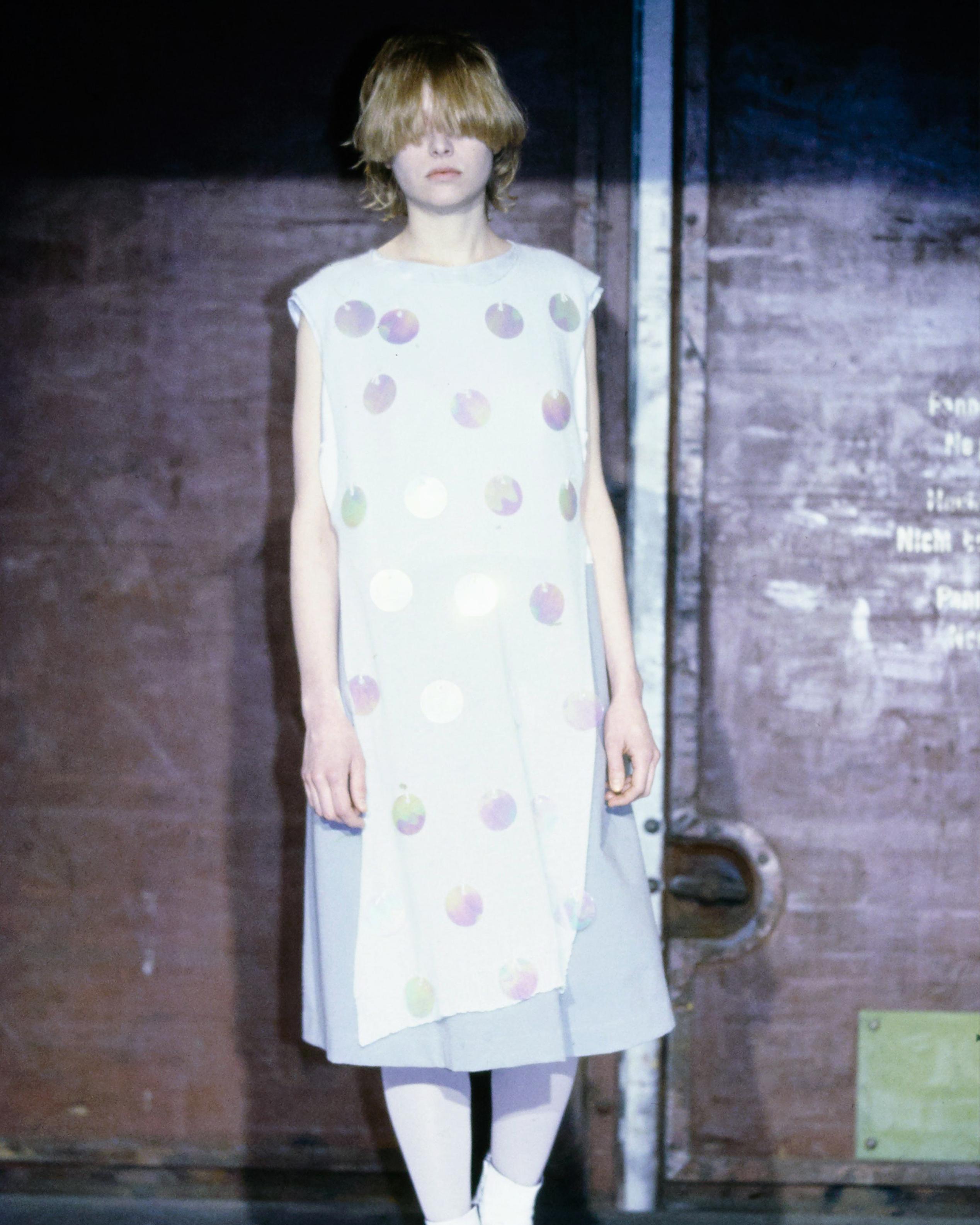 - Entworfen von Martin Margiela
- Herbst-Winter-Kollektion 2000
- Laufstegartikel (Look 14)
- Weiße verschönerte Tunika aus Strick
- Plastikscheiben Verschönerung
- Ärmellos
- Rundhalsausschnitt
- Umgekehrt Hoch-Tief
- Hergestellt in Italien
-