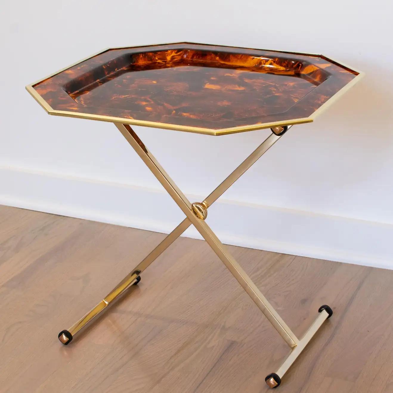 Maison Mercier, Paris, designed and crafted this elegant Mid-Century-Modern barware folding tray table in the 1960s. The large-scale square butler tray is made of Lucite with a faux tortoiseshell (tortoise) textured pattern and gilded brass trim.