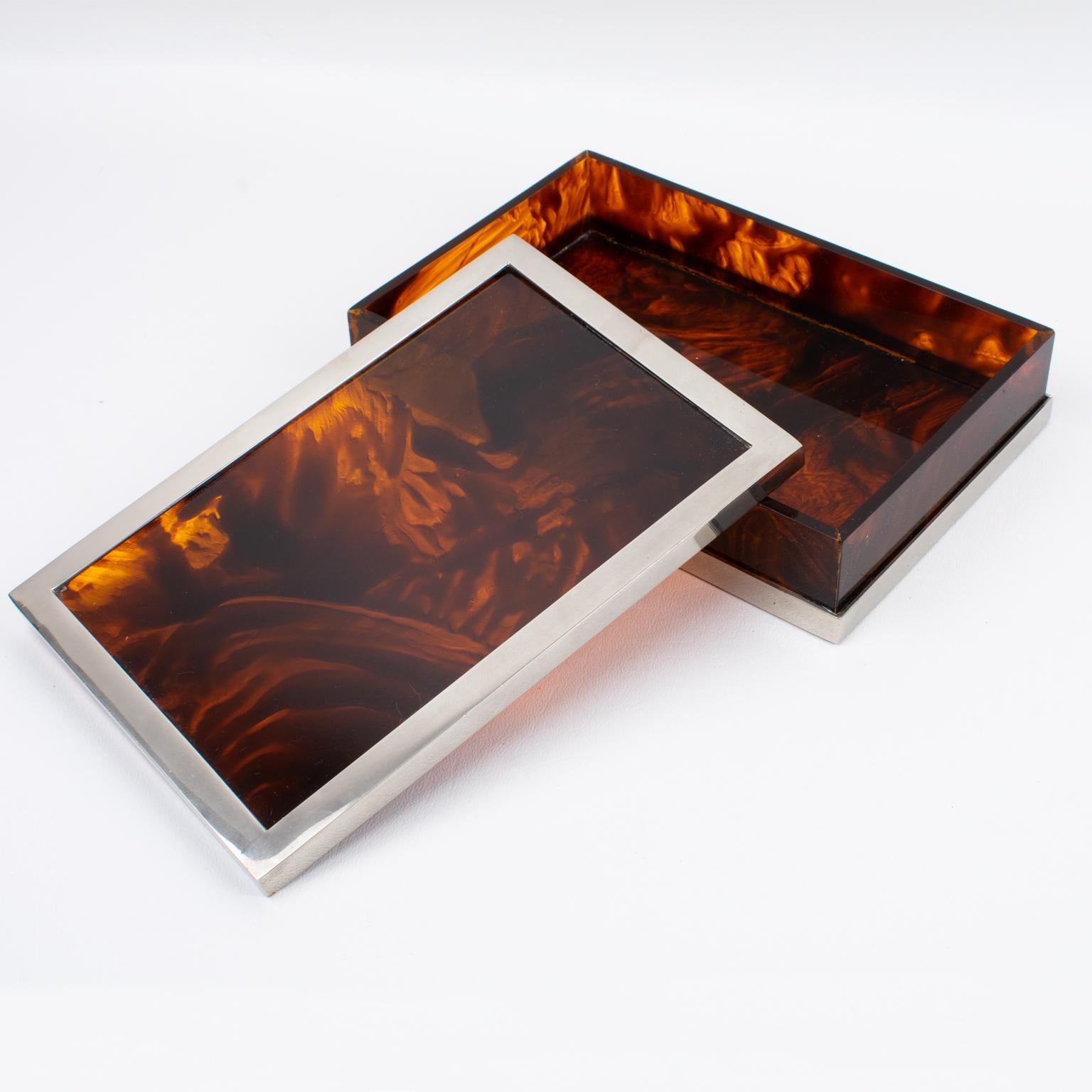 This elegant 1970s rectangular-shaped decorative lidded box was designed by the Parisian luxury house Maison Mercier Freres. It features a thick tortoise (tortoiseshell) pattern Lucite or Plexiglass base and chromed metal framing, which gives it a