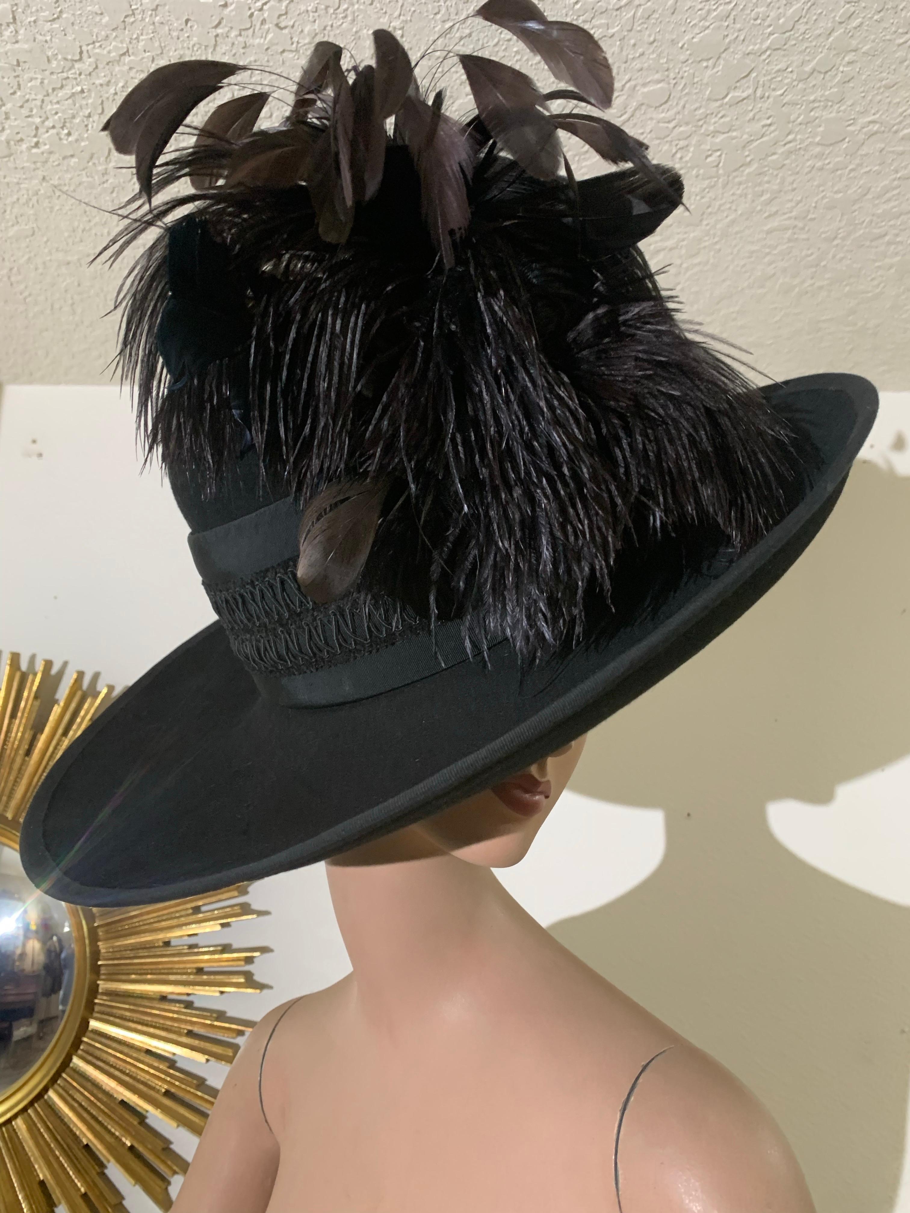 Custom-Made Maison Michele Black Fur Felt Wide Brimmed Fedora Hat w Braid Band & Feather Detail. Extravagant extra-wide curved brim, tall rounded crown with a beautiful passementerie band. Exuberant tuft of ostrich feathers and trimmed coq feathers.