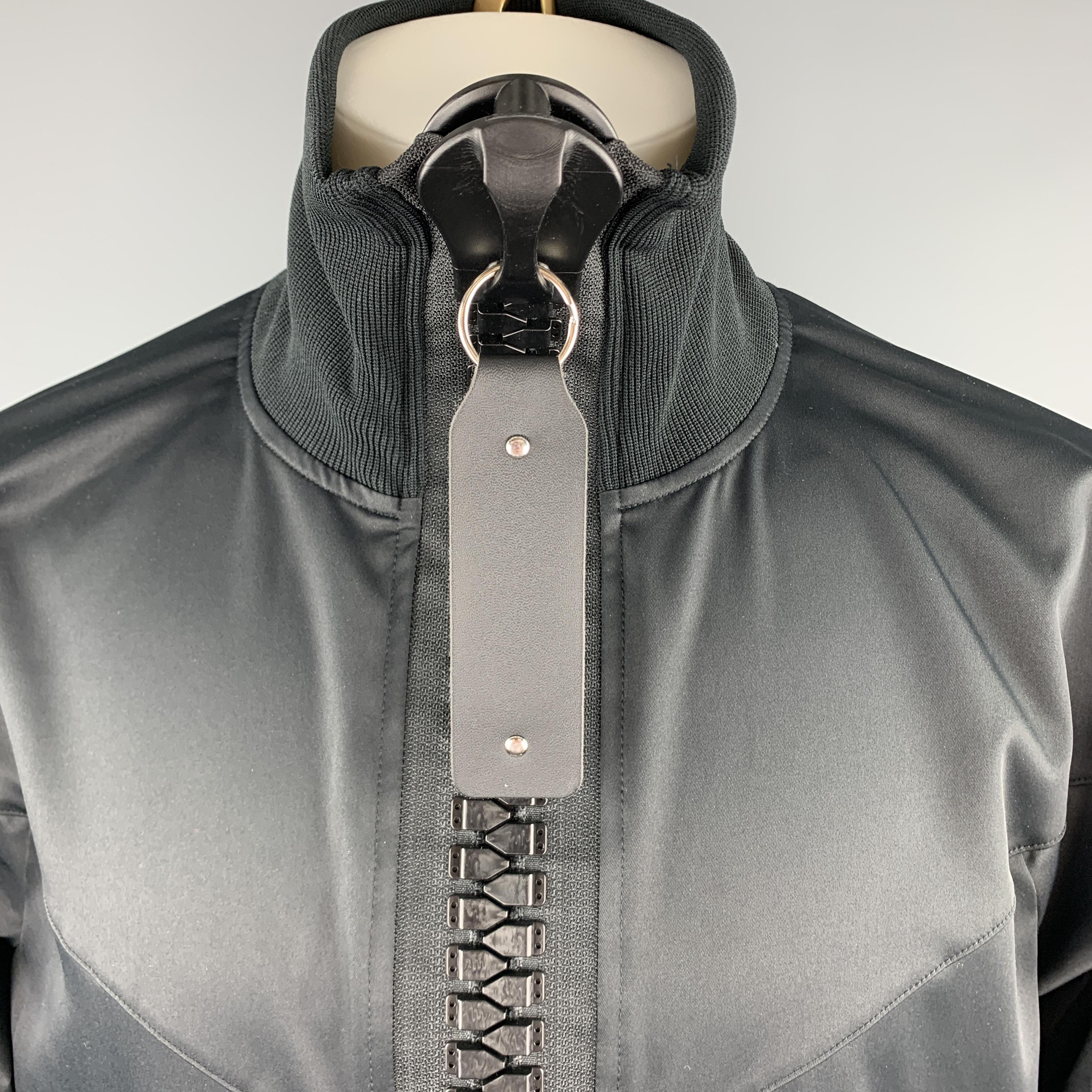 MAISON MIHARA YASUHIRO track jacket comes in black fabric with drop shoulder, burgundy striped sleeves, high ribbed neck, and giant oversized zipper with tab. Made in Japan.

Excellent Pre-Owned Condition. 
Marked: EU 44

Measurements:

Shoulder: 25