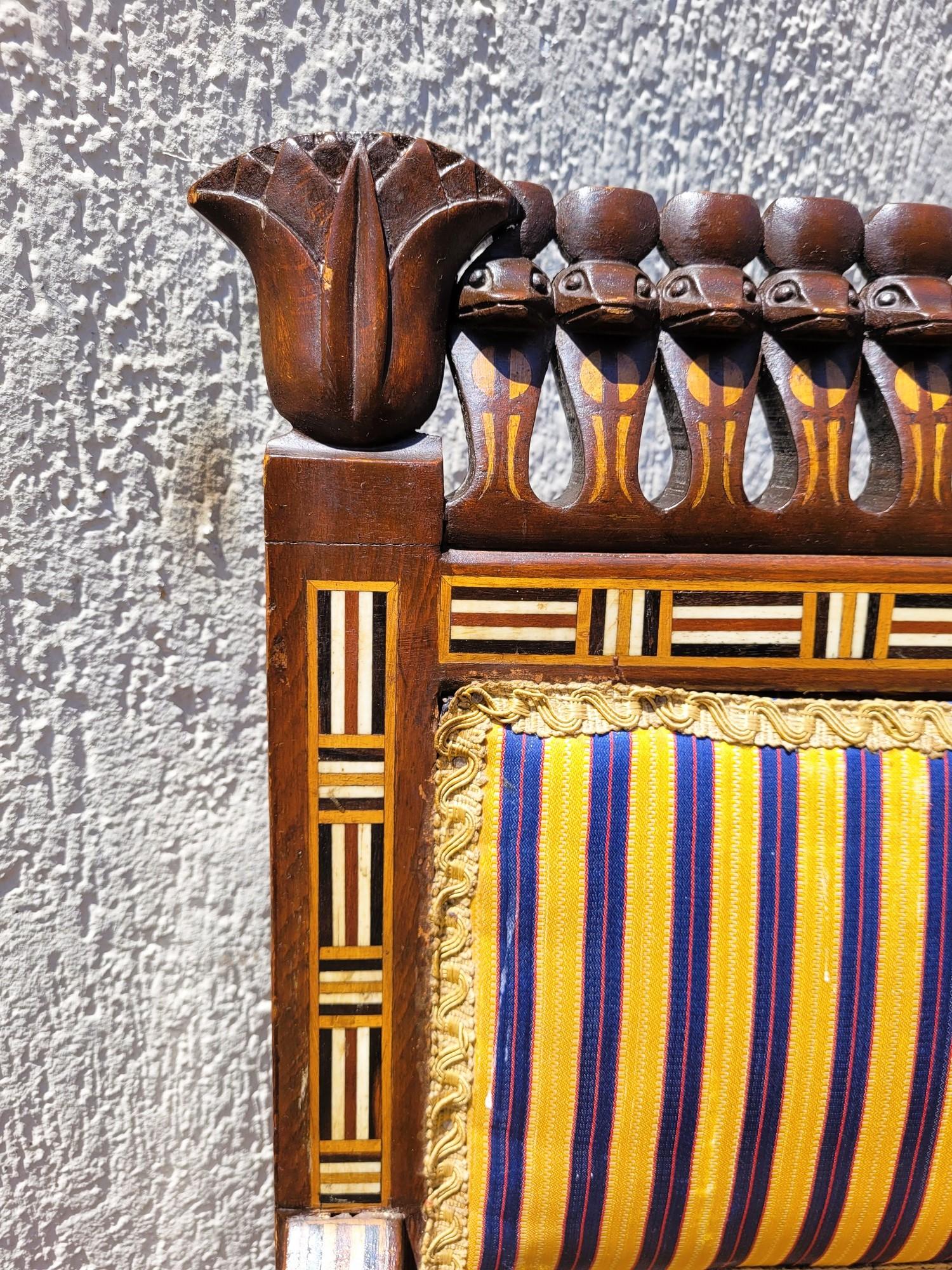 Large Egyptomania lounge of the Parvis house, composed of 2 benches 2 places each and 4 armchairs.

Freely inspired by the furniture discovered in the royal tombs or by the representations of the temples and papyrus, this lounge is richly decorated
