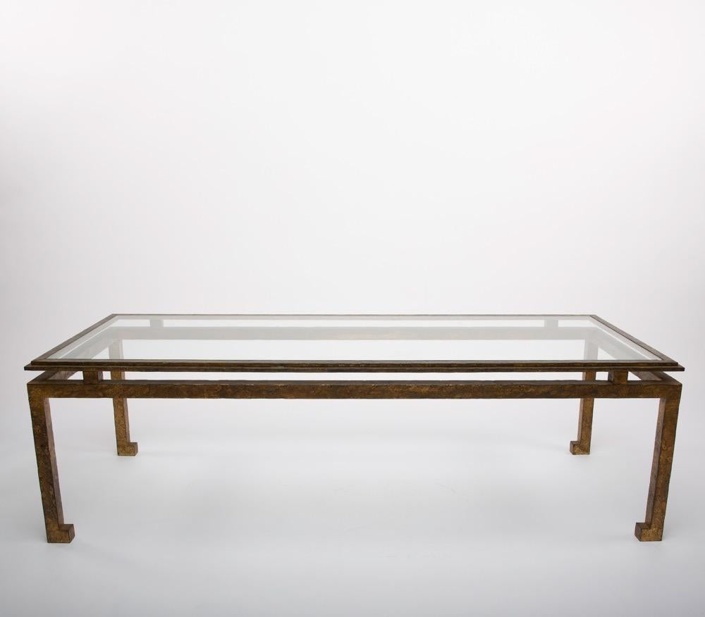 A large midcentury golden iron cocktail or coffee table designed and manufactured by Maison Ramsay, Paris France, circa 1950-1960.
Very clean and sharp lines, the table structure is made from golden beaten iron with a glass top. 

We are located