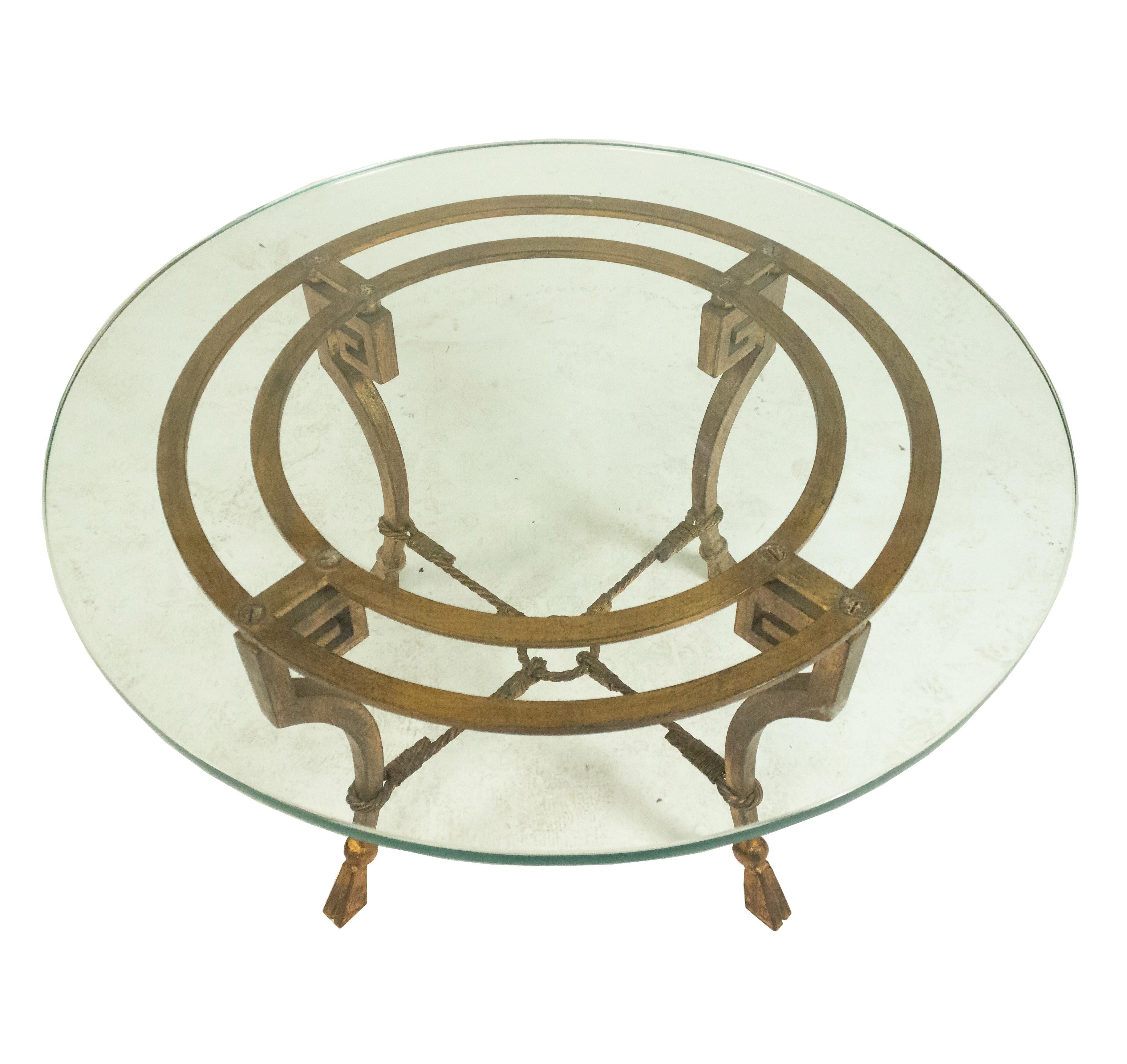 French 1940s Maison Ramsay neoclassical gilt iron coffee table with rope shaped stretcher legs and detachable round glass top.