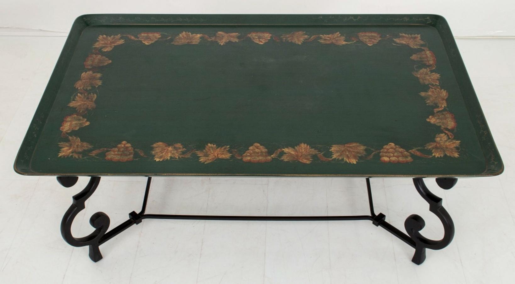 Maison Ramsay manner wrought iron tray table, with a rectangular tray-form top lacquered green with giltwork decoration in the manner of tole peinte, above chamfered corners above scroll supports conjoined by a rectangular stretcher on square