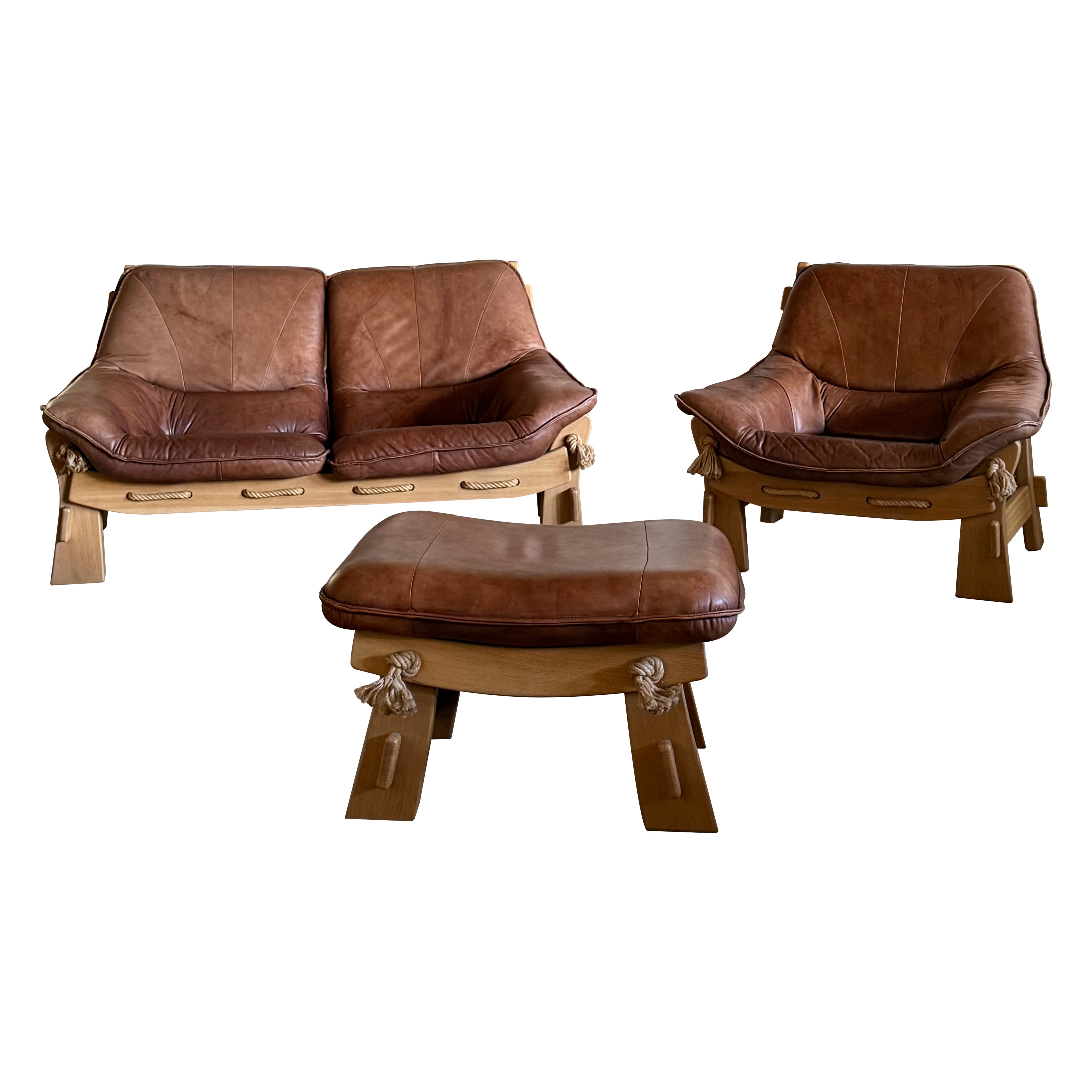 MAISON REGAIN ARMCHAIR, 2-SEATER 
OTTOMAN SET LEATHER OAK WOOD, FRANCE 1960s