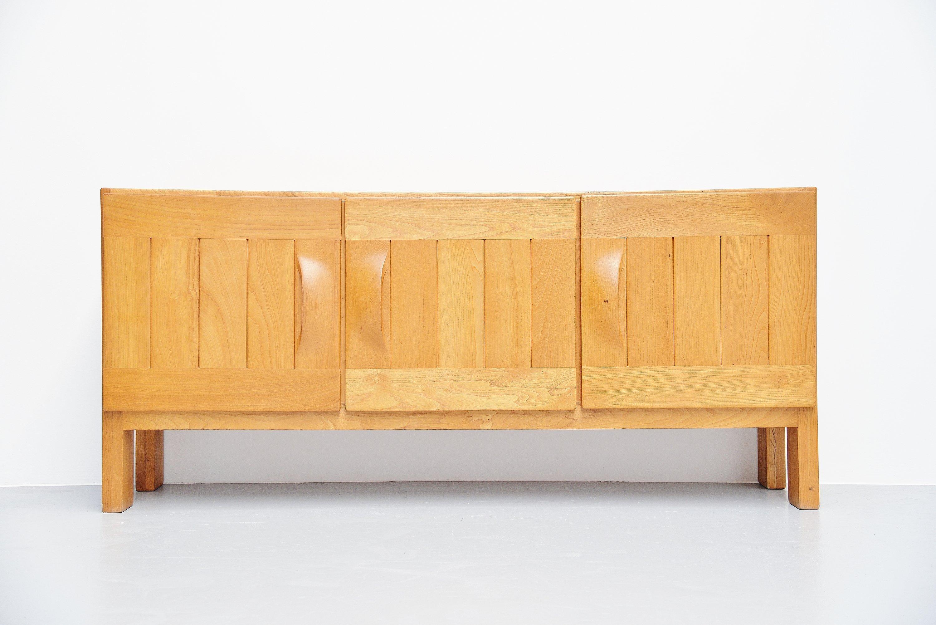 Large Brutalist sideboard designed and manufactured by Maison Regain, France, 1970. This 3-door sideboard was made of solid elm and this is crafted into perfection. Founder of Maison Regain was the previous carpenter of Pierre Chapo. We can see why