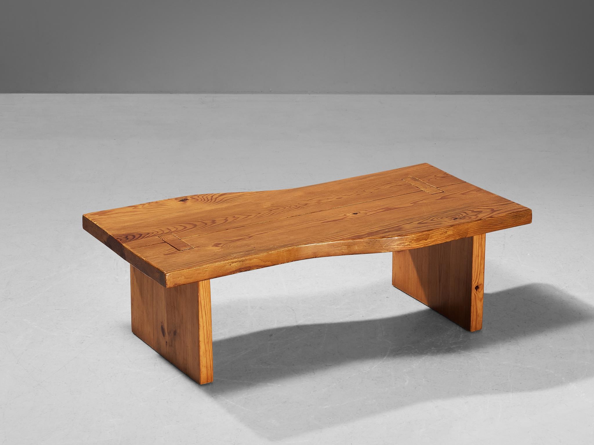 Maison Regain, coffee table, pine, France, 1970s

While the top convinces with its natural and dynamic appearance due to the organic, free flowing edges, the base is expressed through clear lines and symmetrical features. The mortise and tenon