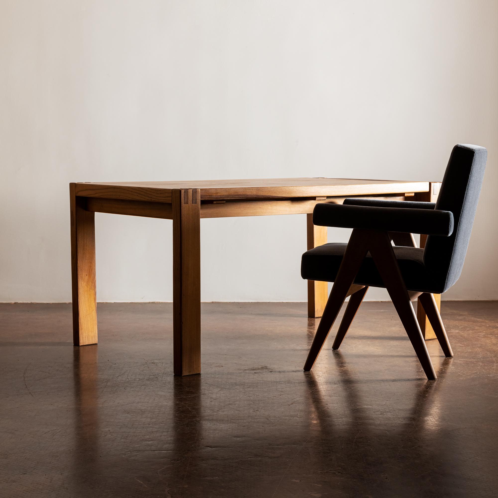A handsome dining table in elm by Maison Regain with two extension leaves. Founder of Maison Regain was previous woodworker with Pierre Chapo. This piece has beautiful details with clear influence by their association with Chapo. France,