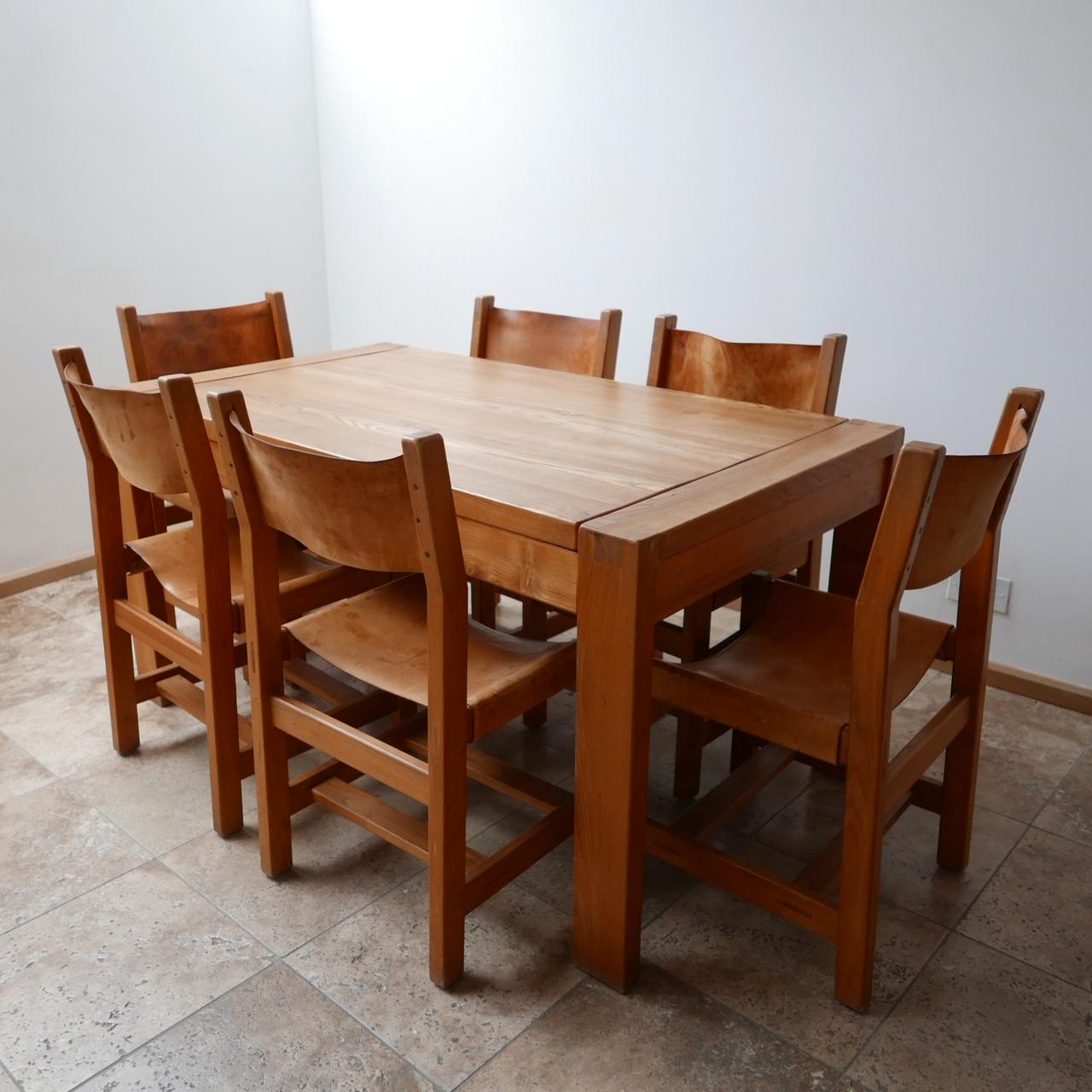 A rare set of Maison Regain dining chairs. 

Solid elm with the original leather. 

These good quality chairs are from the same period and are a similar design of the esteemed Pierre Chapo. 

French, circa 1970s. 

Patination and wear to the