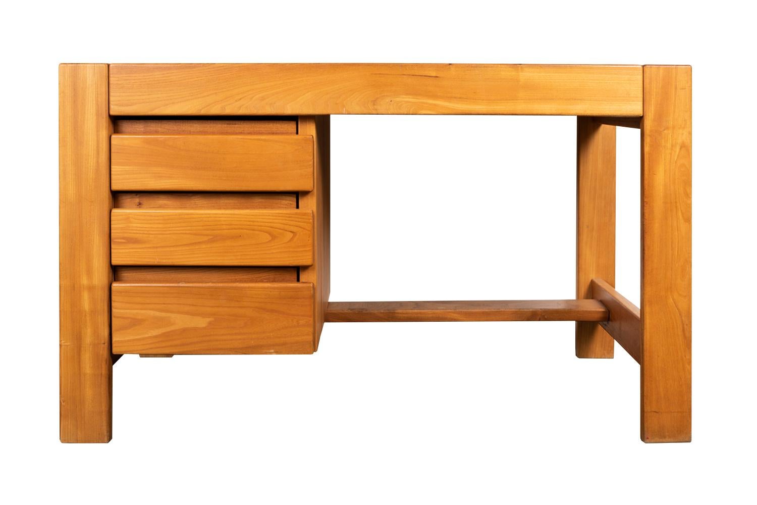 Maison Regain, attributed to
Pierre Chapo, in the style of

Elm desk with a left compartment opening by three drawers. It stands on four rectangular shape legs linked to each other by a central stretcher and two others located perpendicularly on