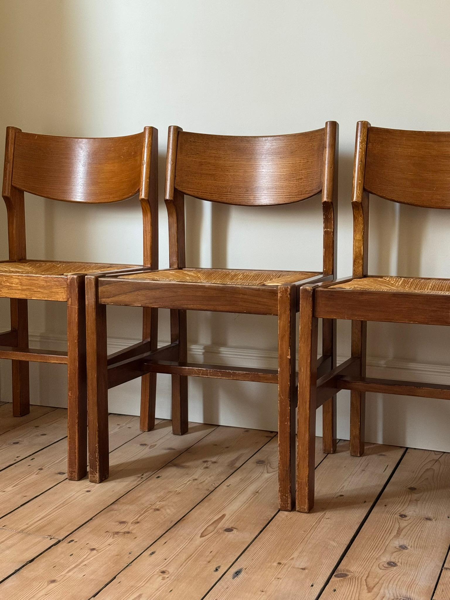 A set of four brutalist dining chairs designed by Maison Regain. Beautiful shape and structurally sound. Visible wear to the solid elm frames and original straw seats.

France c. 1960s

H80 x W47 x D47cm