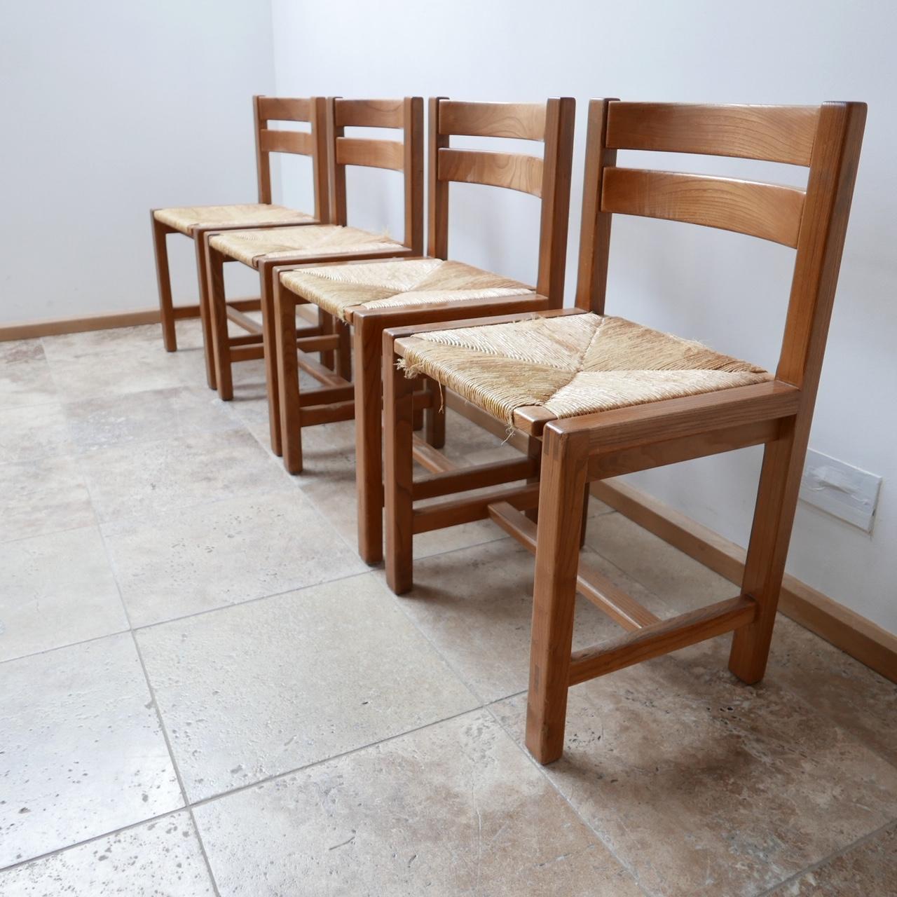 A set of four dining chairs by Maison Regain,

French, circa 1970s.

Solid elm. 

Maison Regain were competitors to Pierre Chapo and made pieces in the same style and construction during the same period. The chairs are very well made and good