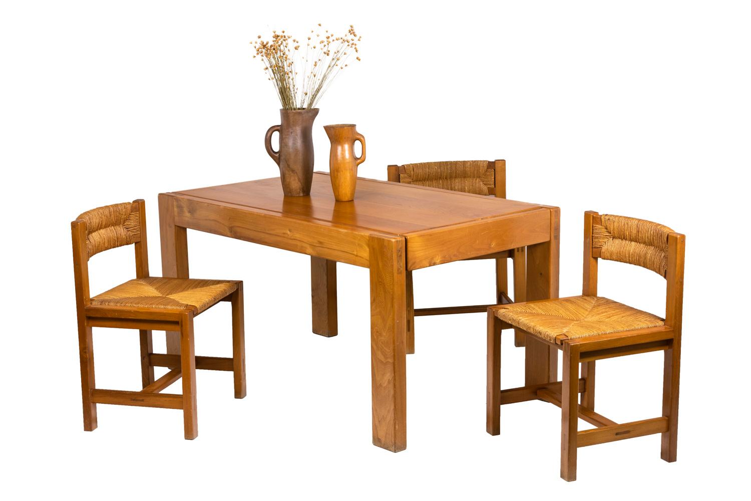 Maison Regain, attributed to.

Series of six chairs in blond elm. The four rectangular-section feet are linked by a H-spacer. Posterior studs form the feet and the back which receive a slightly curved straw slightly curved back. Strawed seat